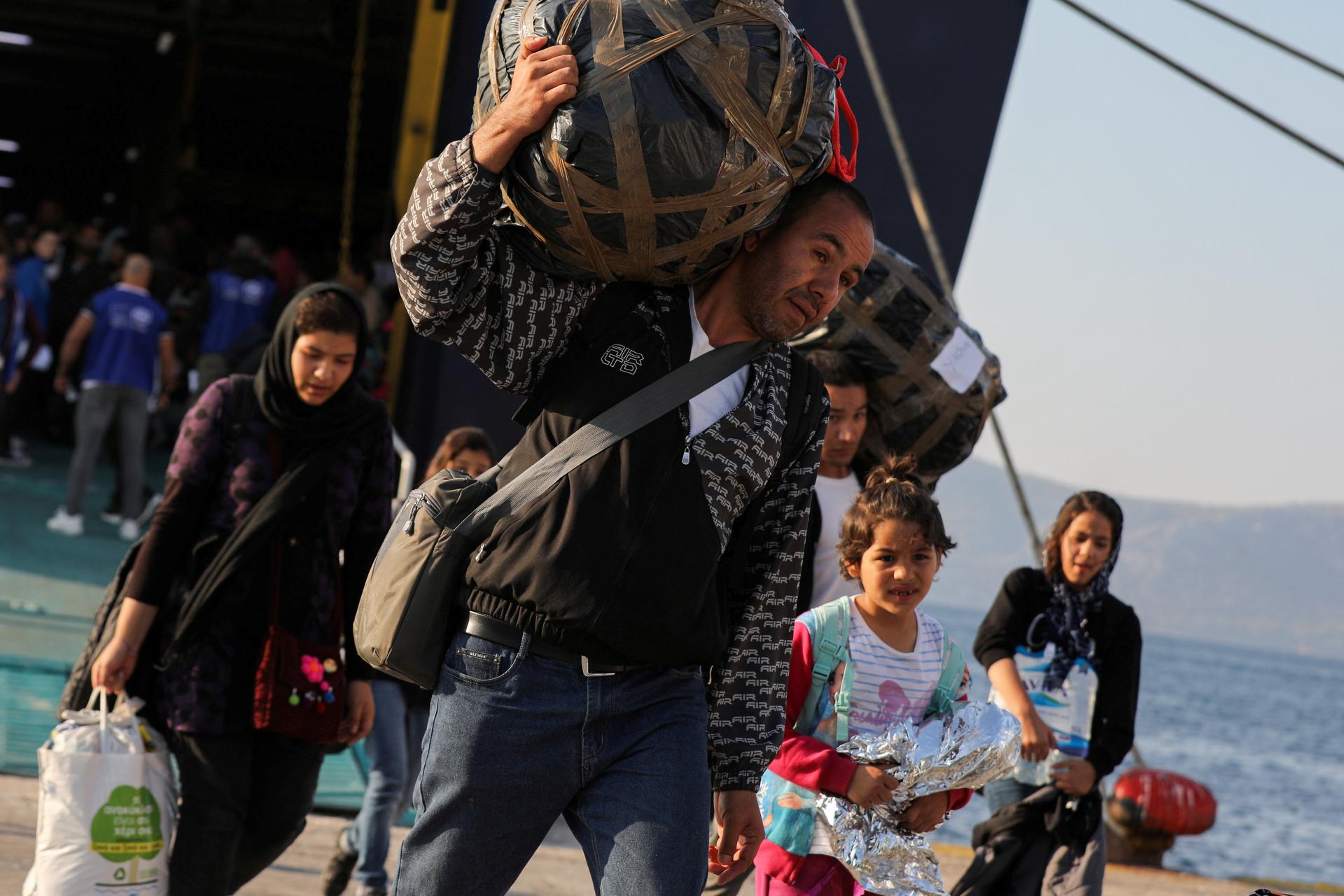  Refugees and migrants arrive aboard the Paros Jet passenger ship at the port of Elefsina near Athens, Greece, Oct. 22, 2019. 