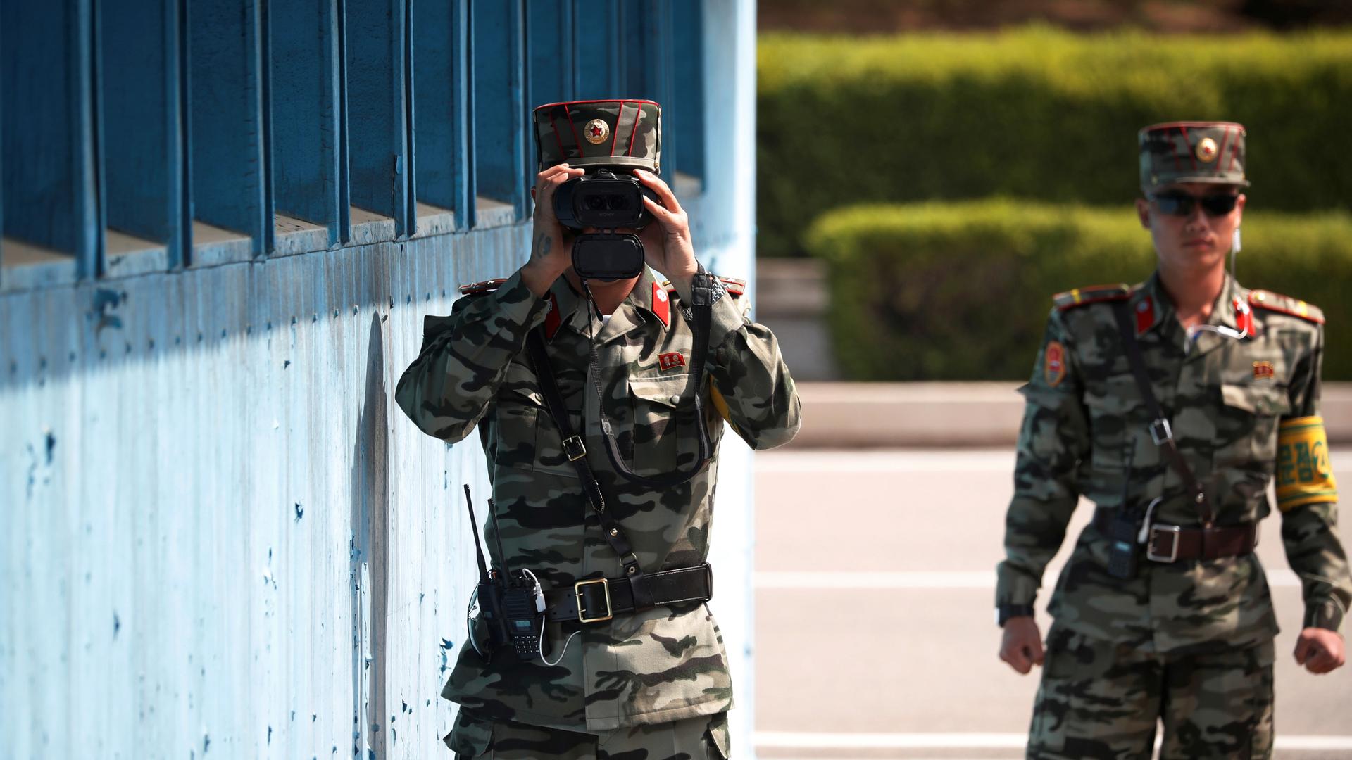A North Korean soldier keeps watch toward the south through a binocular telescope