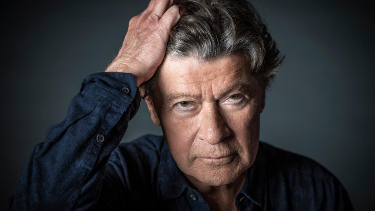 Robbie Robertson looks at the camera posing for a photo