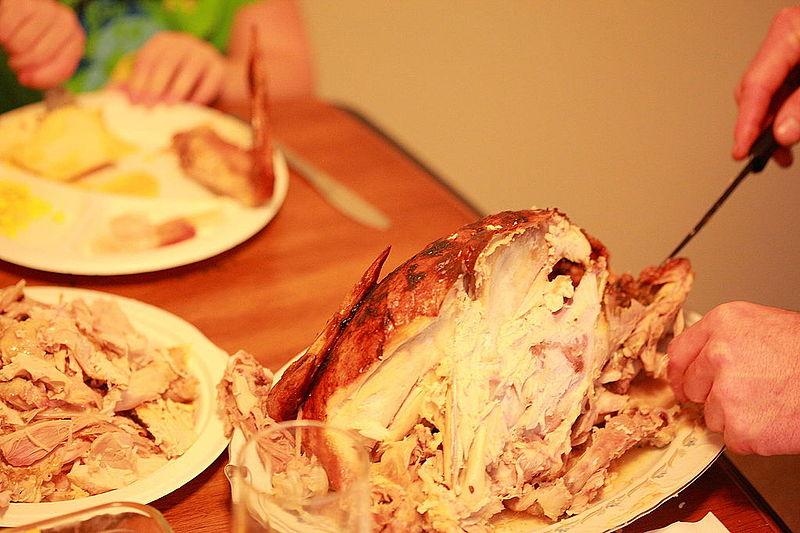 A person carves a turkey
