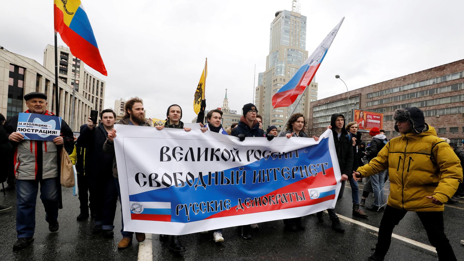 People walk with a banner that reads: "Great Russia, Free internet".