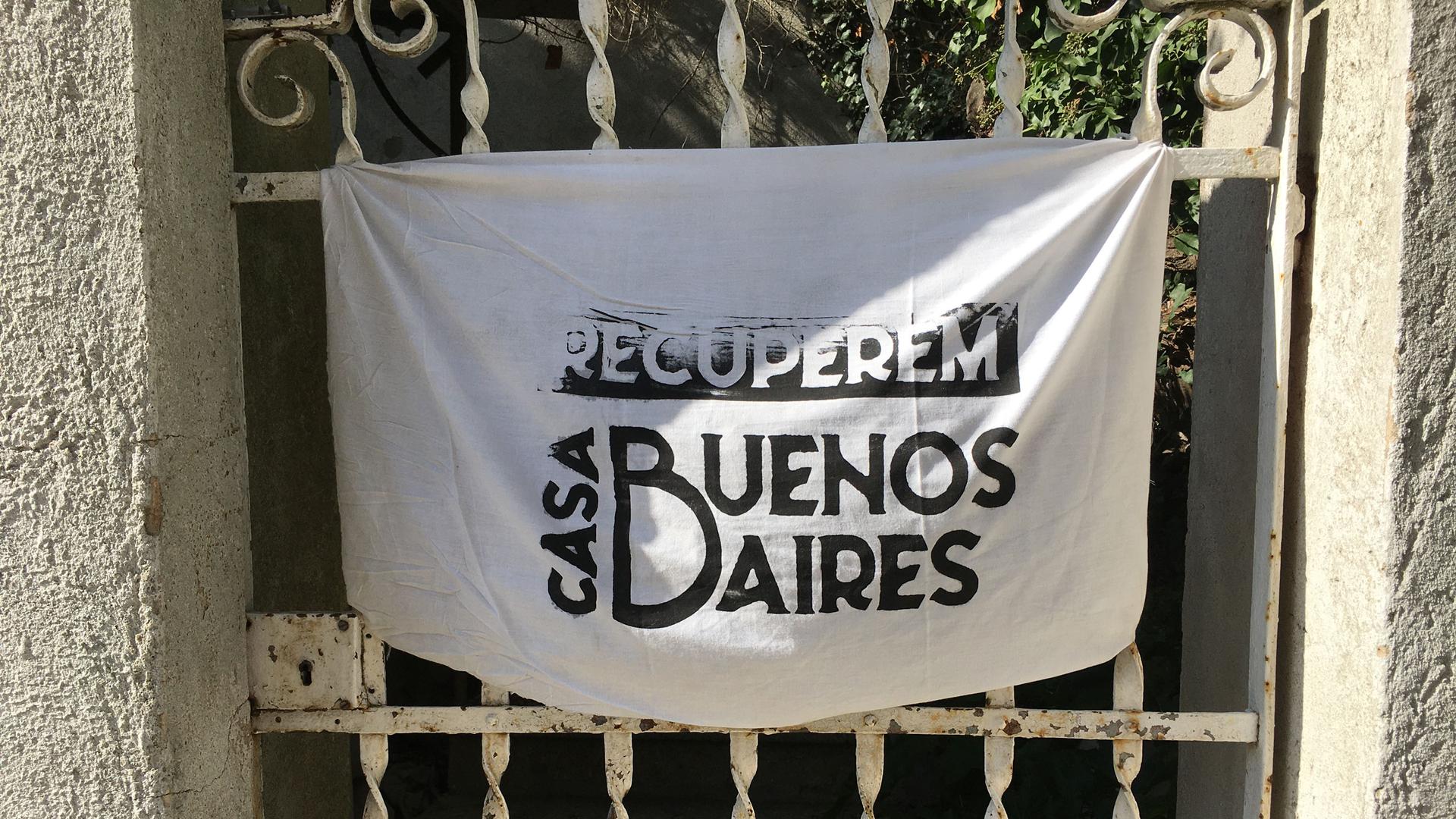 A sign hanging from a private home across from Casa Buenos Aires says in Catalan: 