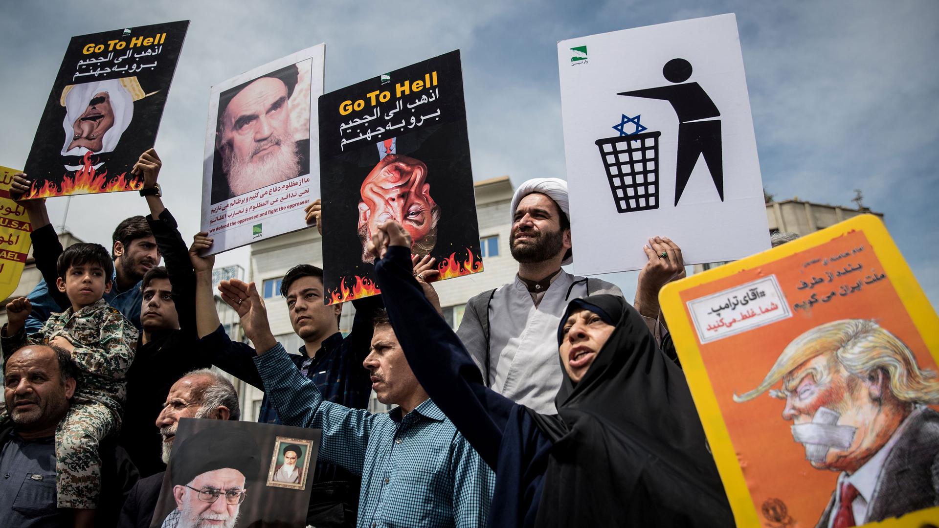 Iranians shout slogans during a protest 