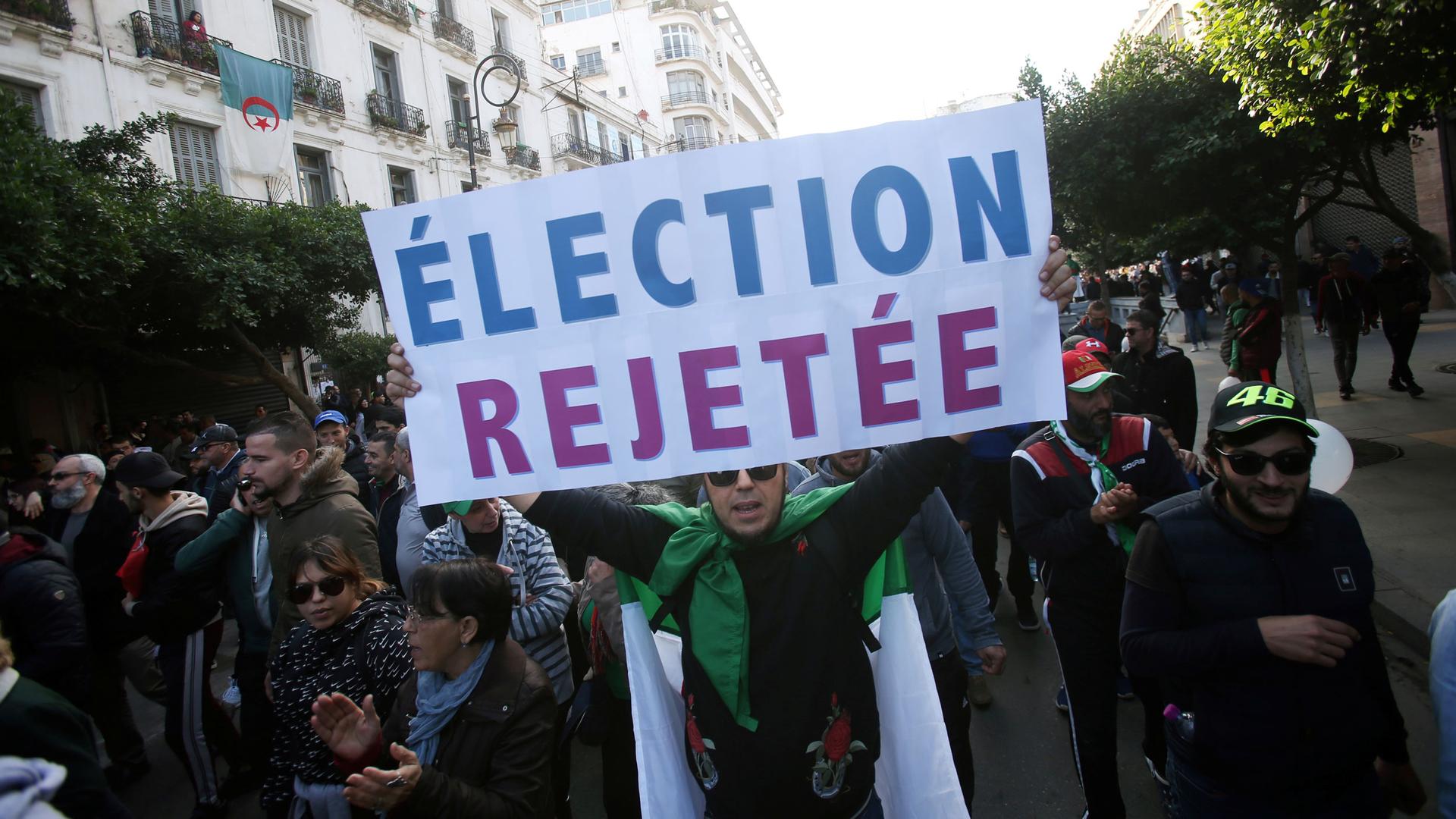 Demonstrators shout slogans during a protest to reject the presidential election in Algiers, Algeria, Dec. 12, 2019.