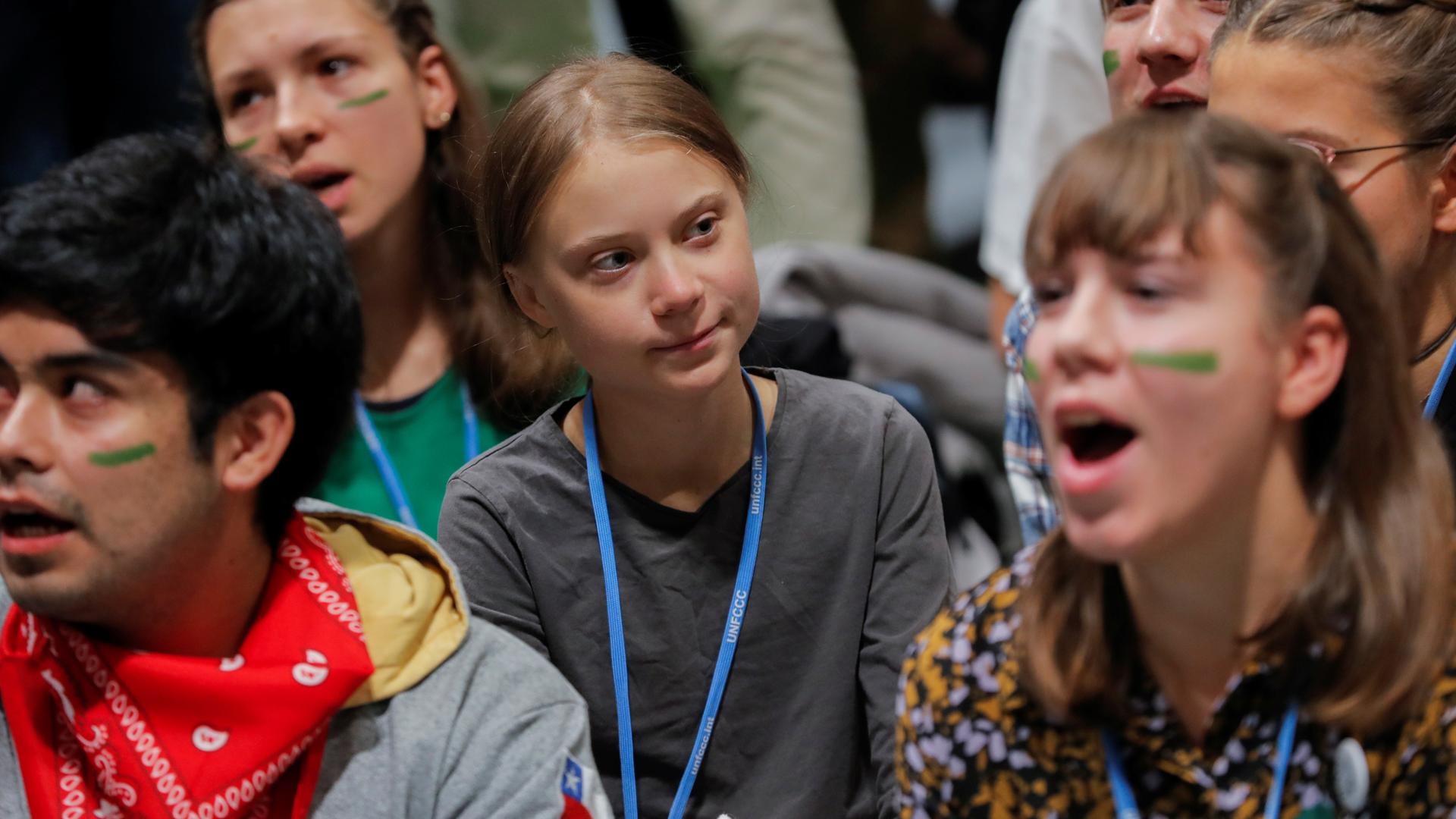 Young climate change activists sit with activist Greta Thunberg in a huddle at the climate talks in Madrid. 