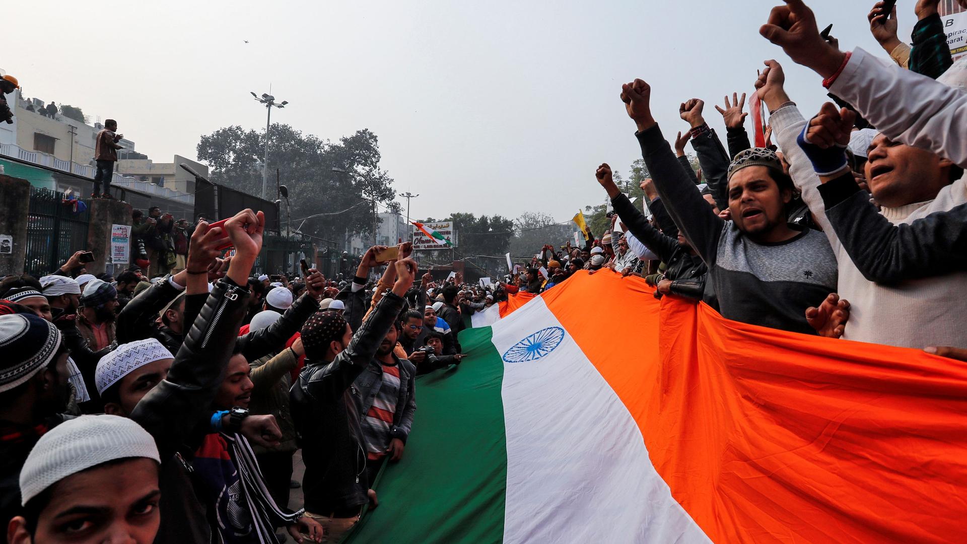 Protesters hold Indian flag in Delhi