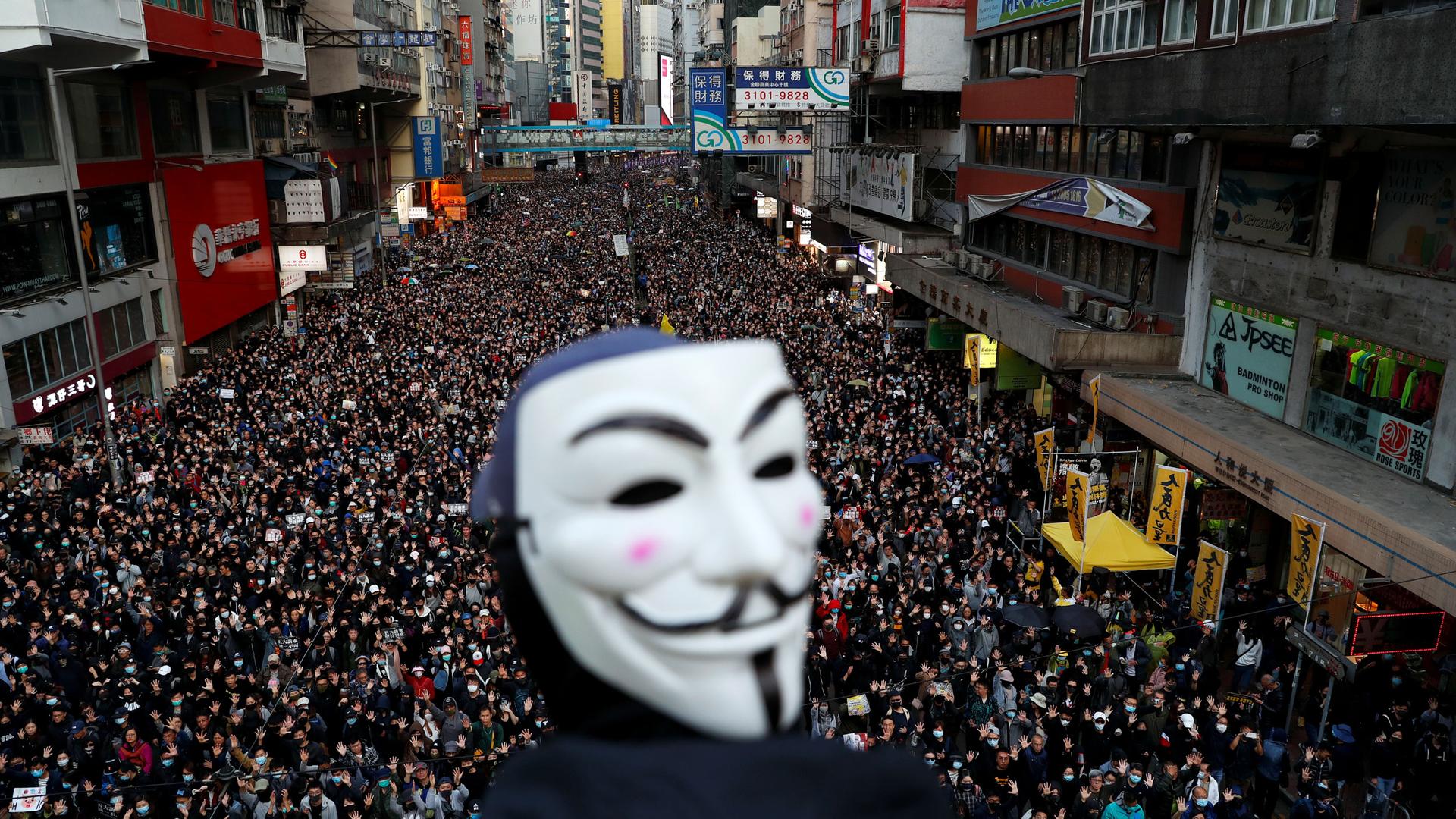 A protester wearing a Guy Fawkes mask attends a Human Rights Day march organized by the Civil Human Right Front, in Hong Kong, China, on Dec. 8, 2019.
