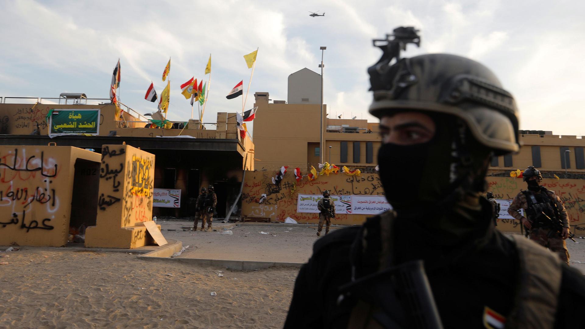 Members of Iraqi security forces are seen in front of US Embassy during a protest.