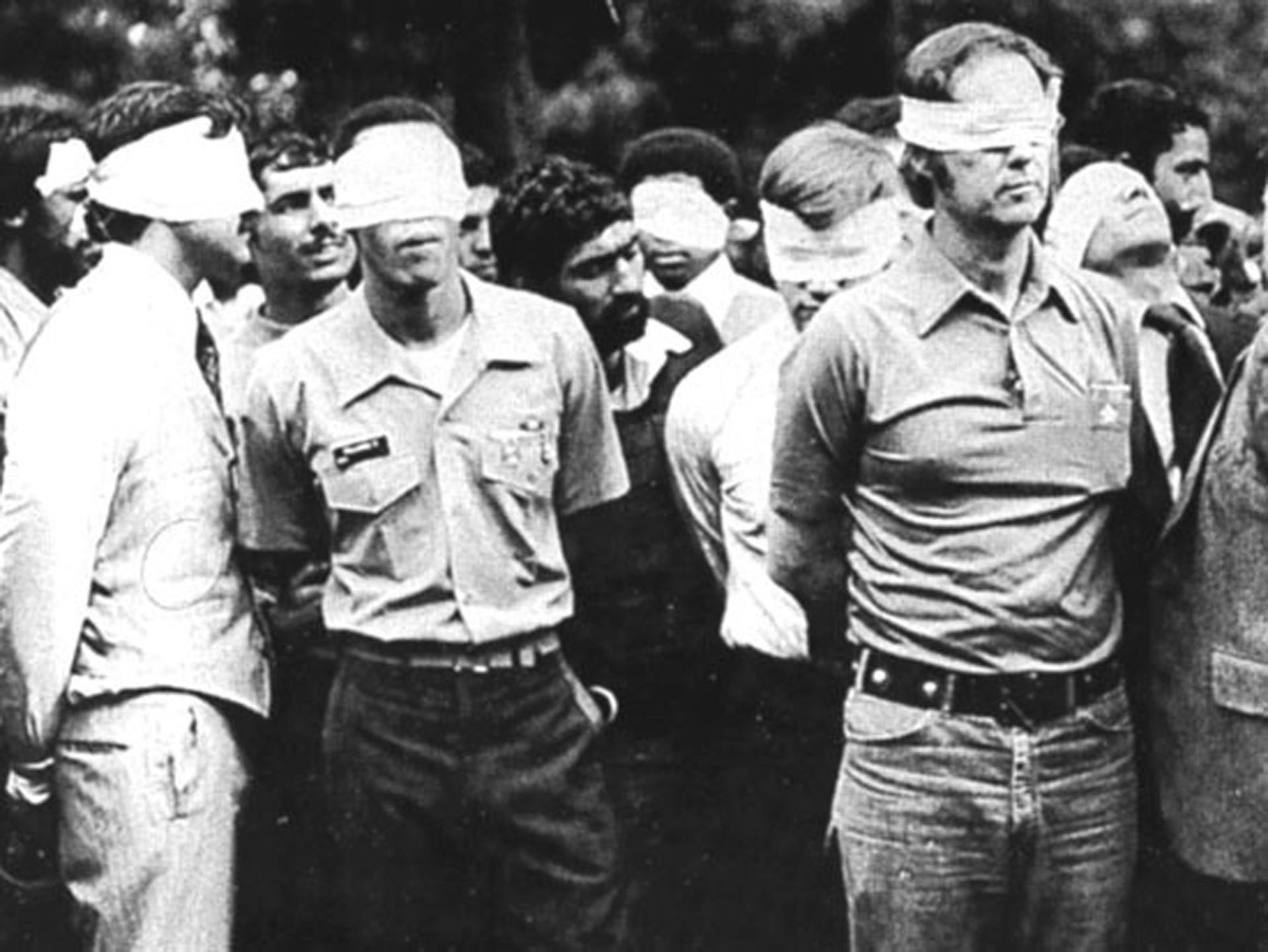 Blindfolded US hostages and their Iranian captors outside the US Embassy in Tehran, Iran, 1979.