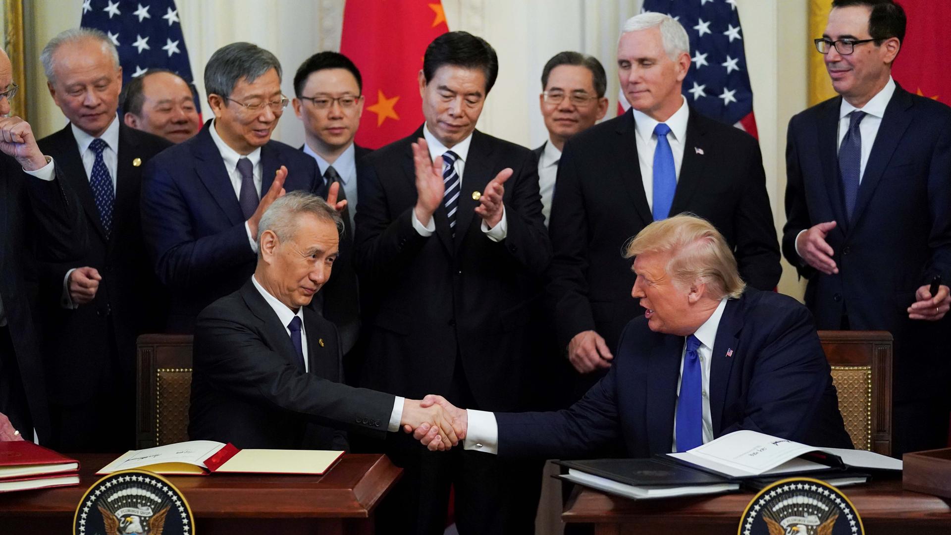 Chinese Vice Premier Liu He and US President Donald Trump shake hands after signing phase one of the US-China trade agreement during a ceremony in the East Room of the White House in Washington, DC, on January 15, 2020.
