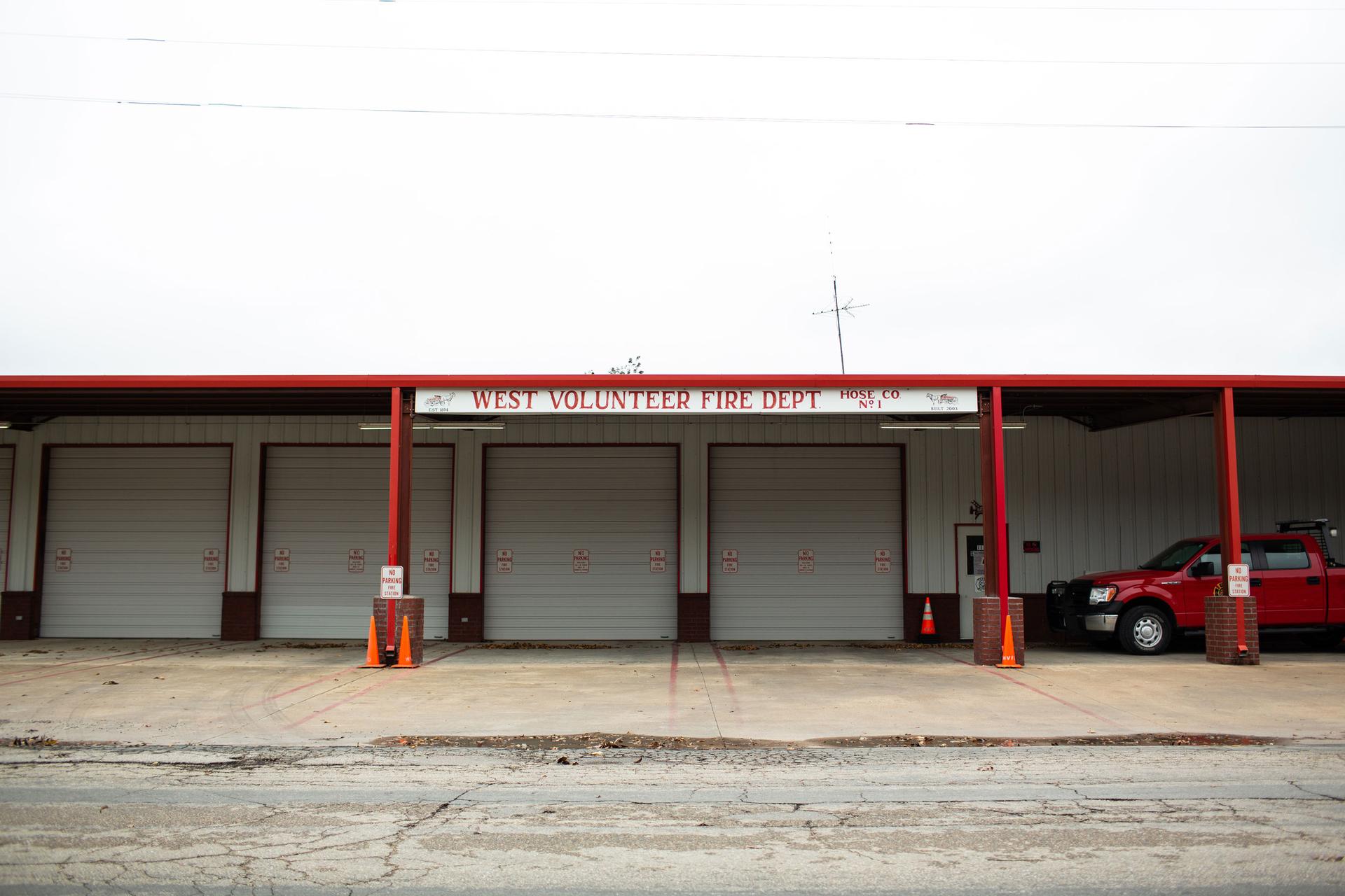 A four bay garage is shown with a red truck on one side.