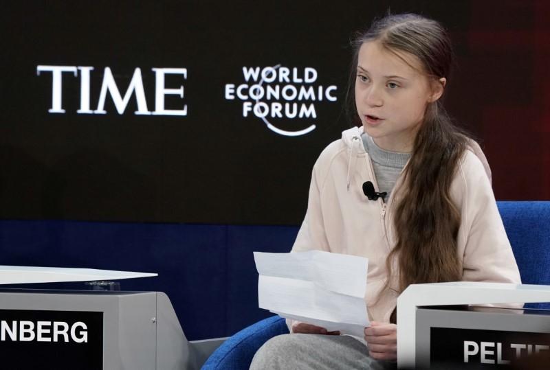 Greta Thunberg sits at the World Economic Forum. 