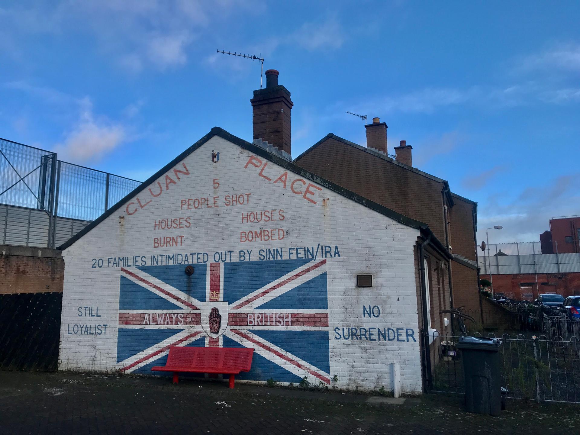 A side of a house is painting with British loyalist colors and message.