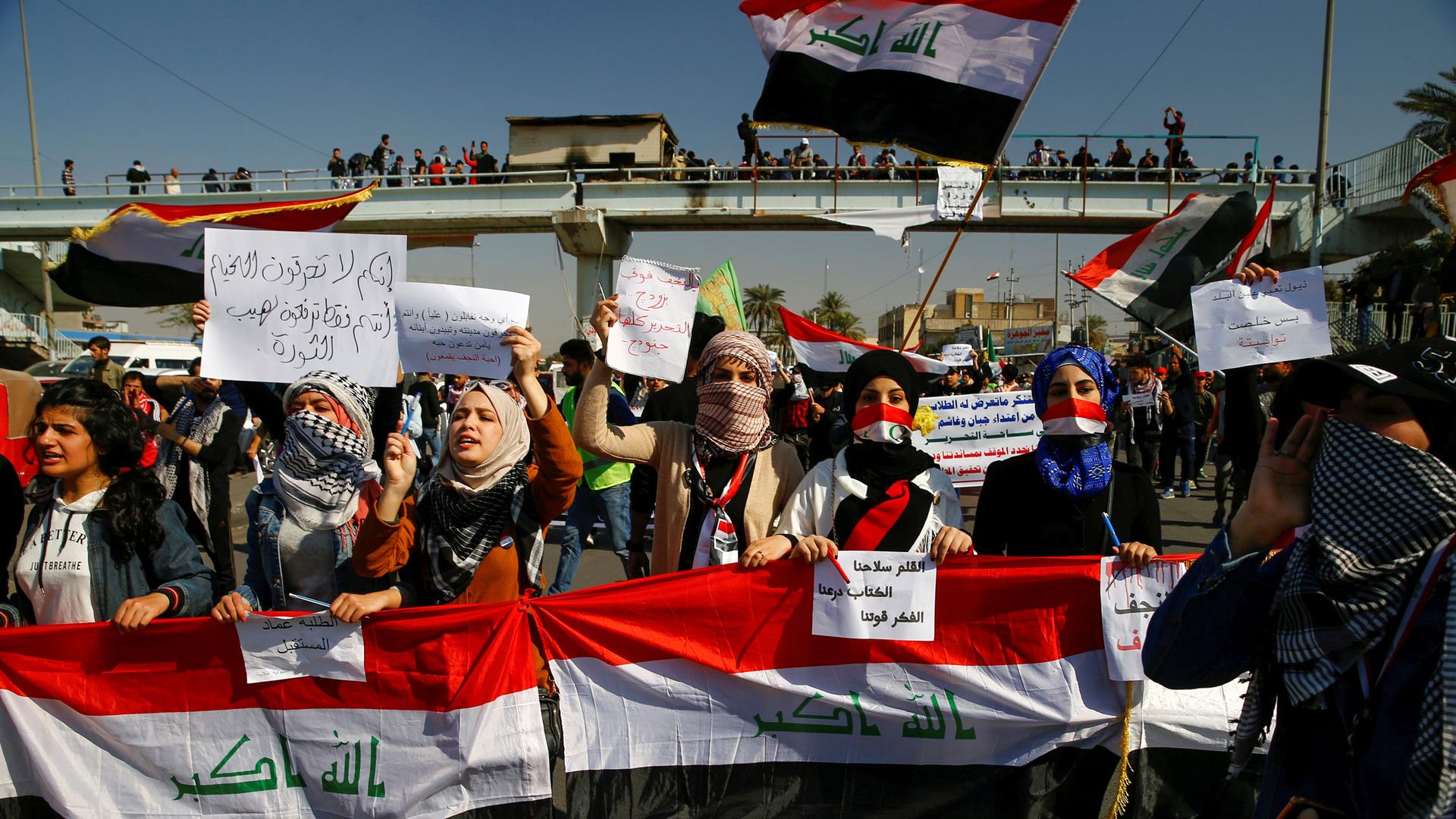University students hold banners as they gather during ongoing anti-government protests in Baghdad, Iraq, Feb. 6, 2020. 