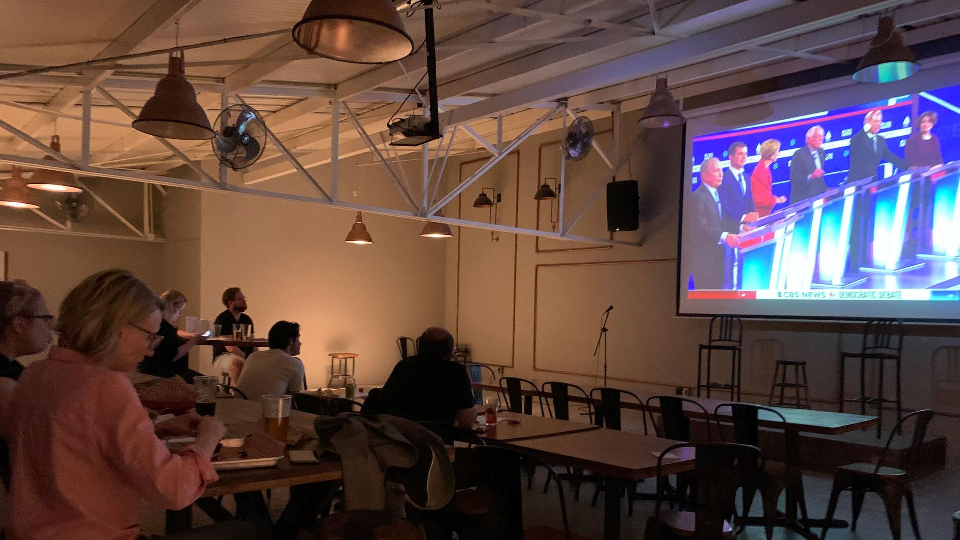 A group of American voters gathered at a BBQ restaurant in Mexico City to watch the Democratic presidential debate broadcast from Charleston, South Carolina, Feb. 25, 2020.