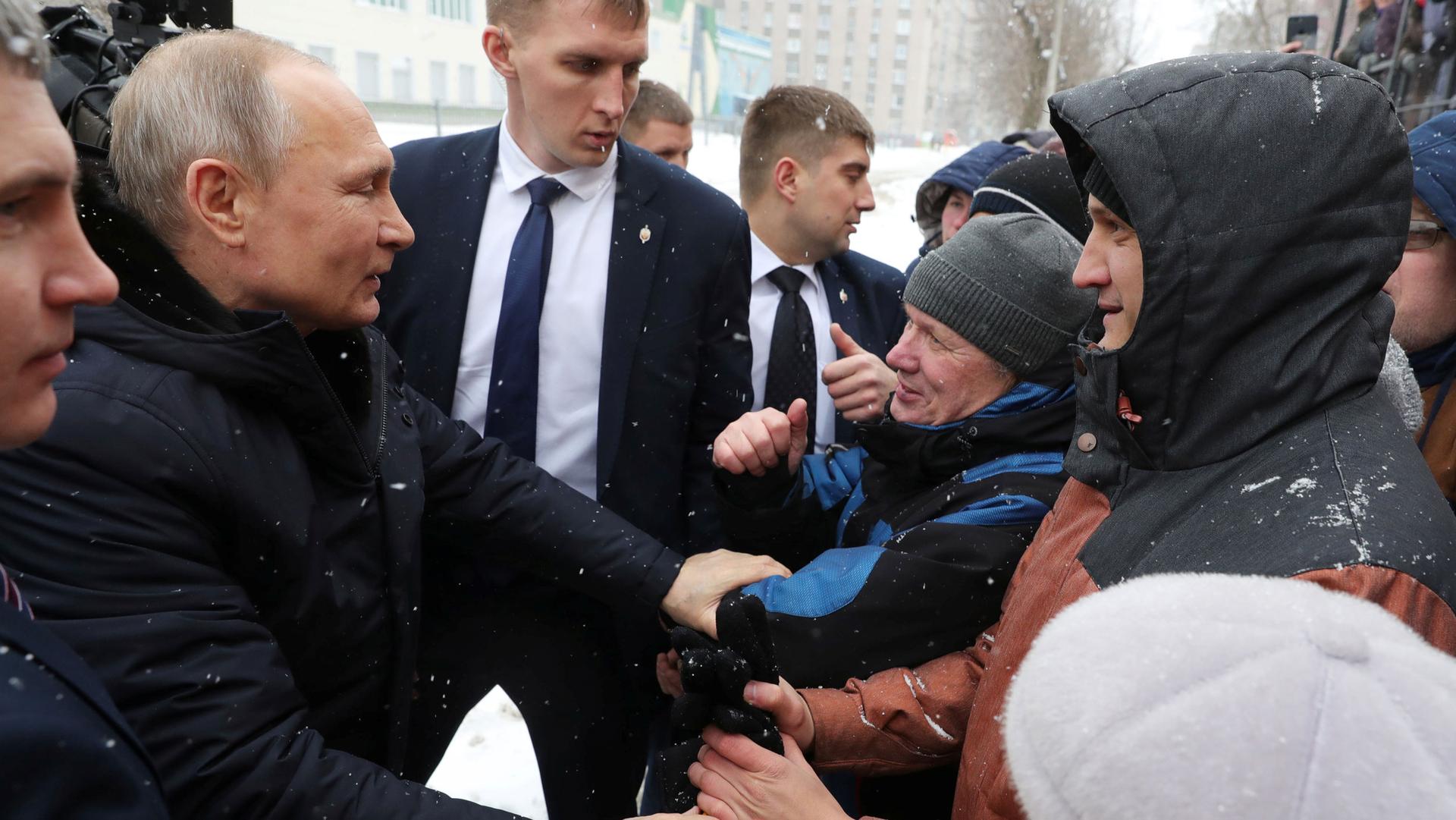Russian President Vladimir Putin greets local residents before visiting a college of chemical technology in Cherepovets, Russia, Feb. 4, 2020.