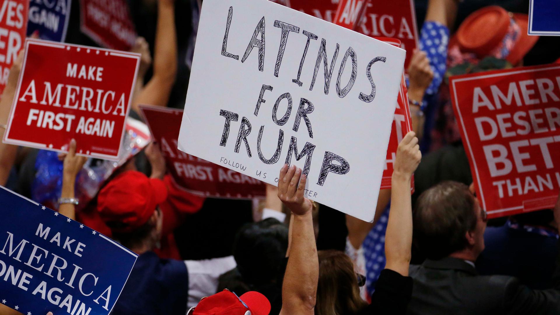 A person holds a sign reading 'Latinos for Trump' on the third day of the Republican National Convention in Cleveland, Ohio, U.S. July 20, 2016.