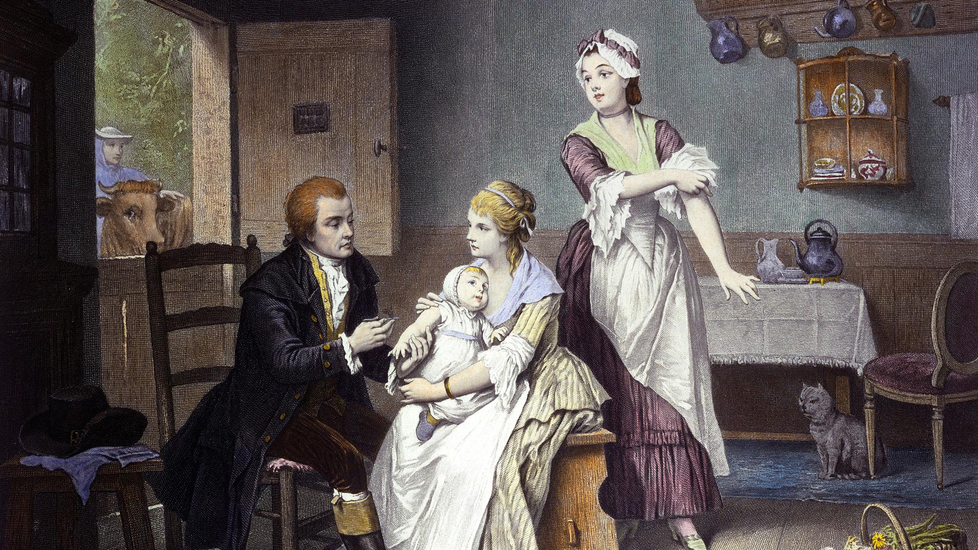 Edward Jenner, vaccinating his young child, held by Mrs. Jenner; a maid rolls up her sleeve, a man stands outside holding a cow. Coloured engraving by C. Manigaud after E Hamman.