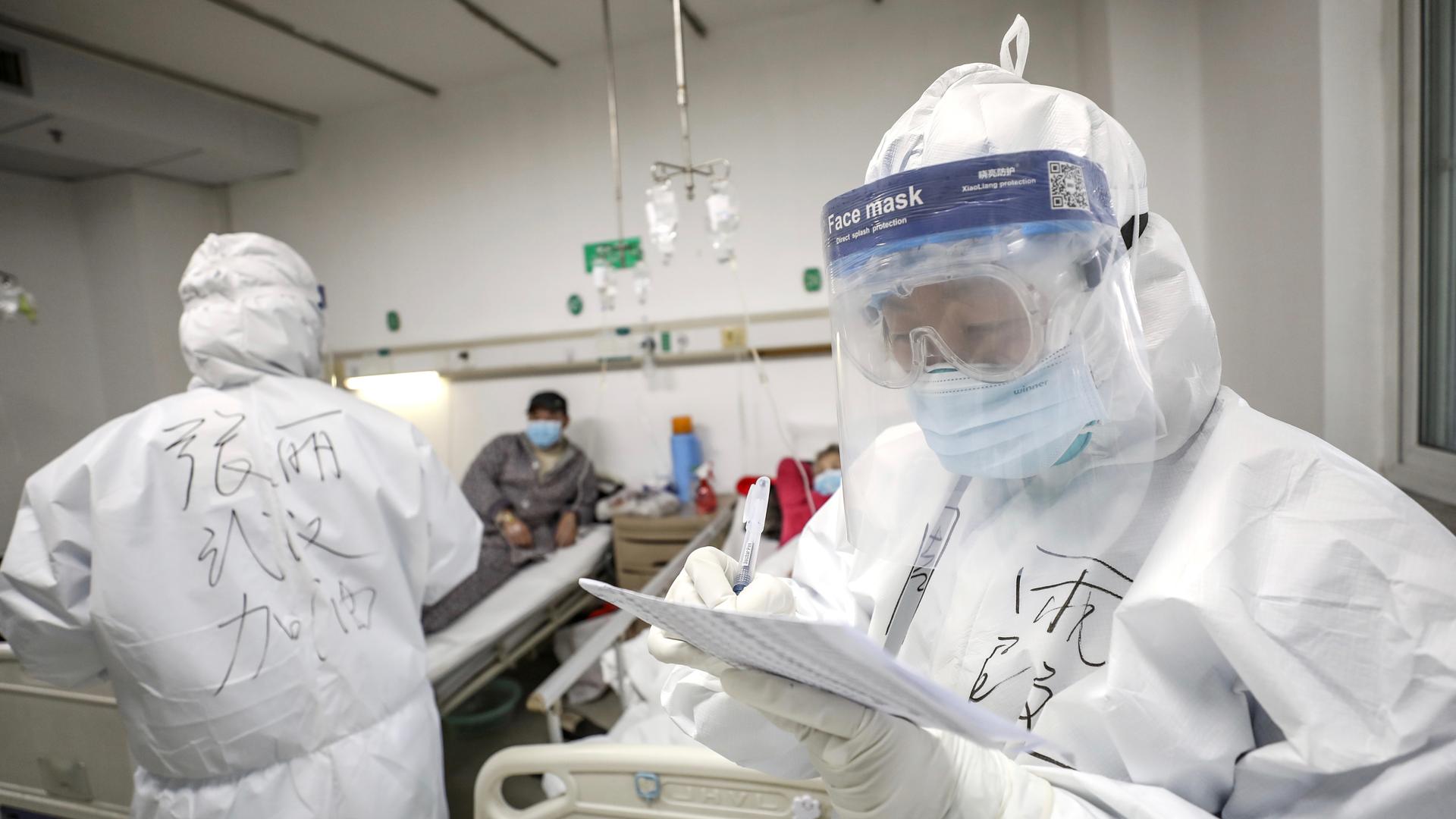 A medical worker in protective suit checks a patient's records at Jinyintan hospital in Wuhan, the epicentre of the novel coronavirus outbreak, in Hubei province, China, Feb. 13, 2020. 