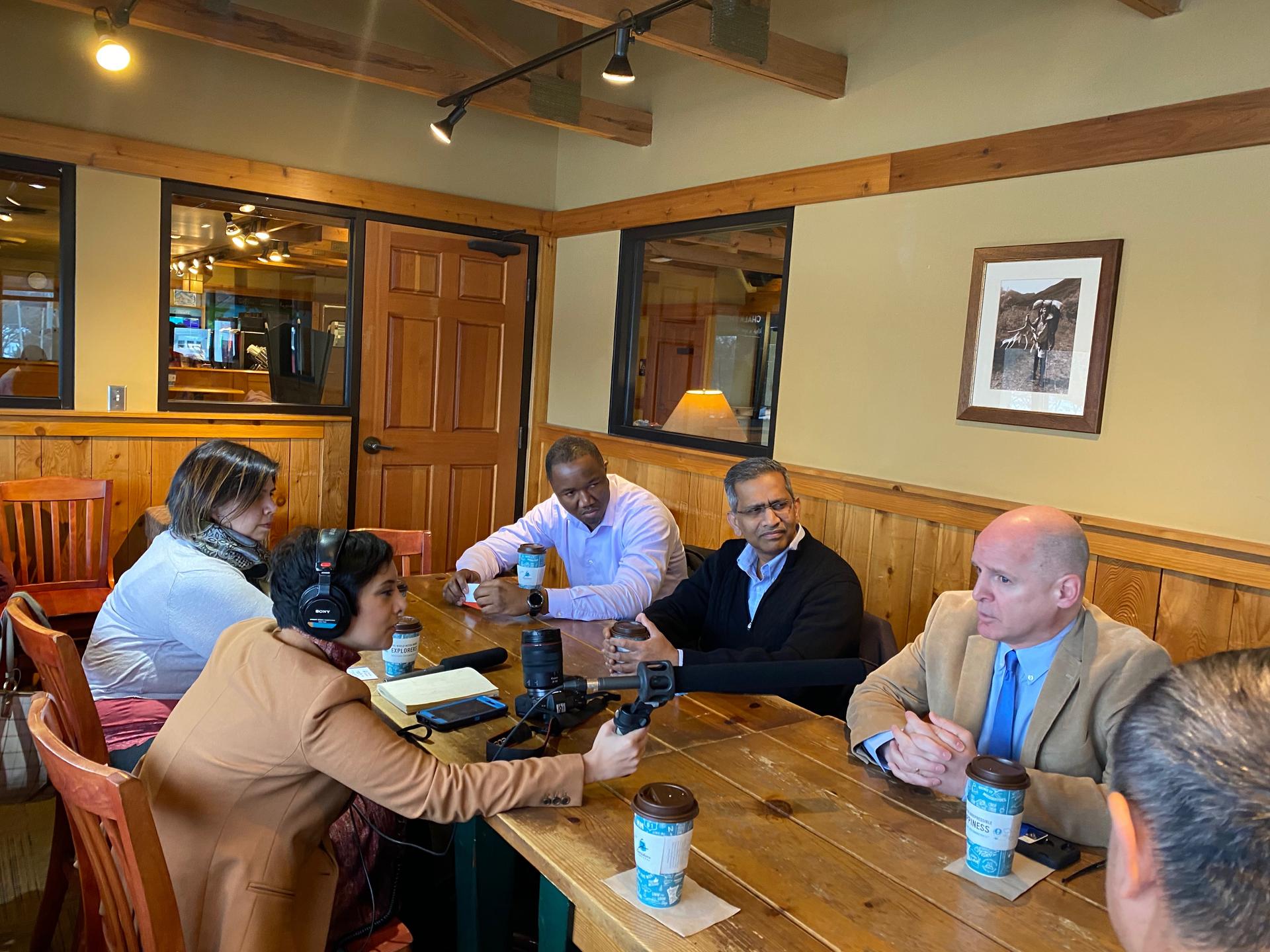 Reporter Rupa Shenoy meets with politically active immigrants and refugees in the back conference room of a Caribou Coffee in Des Moines.