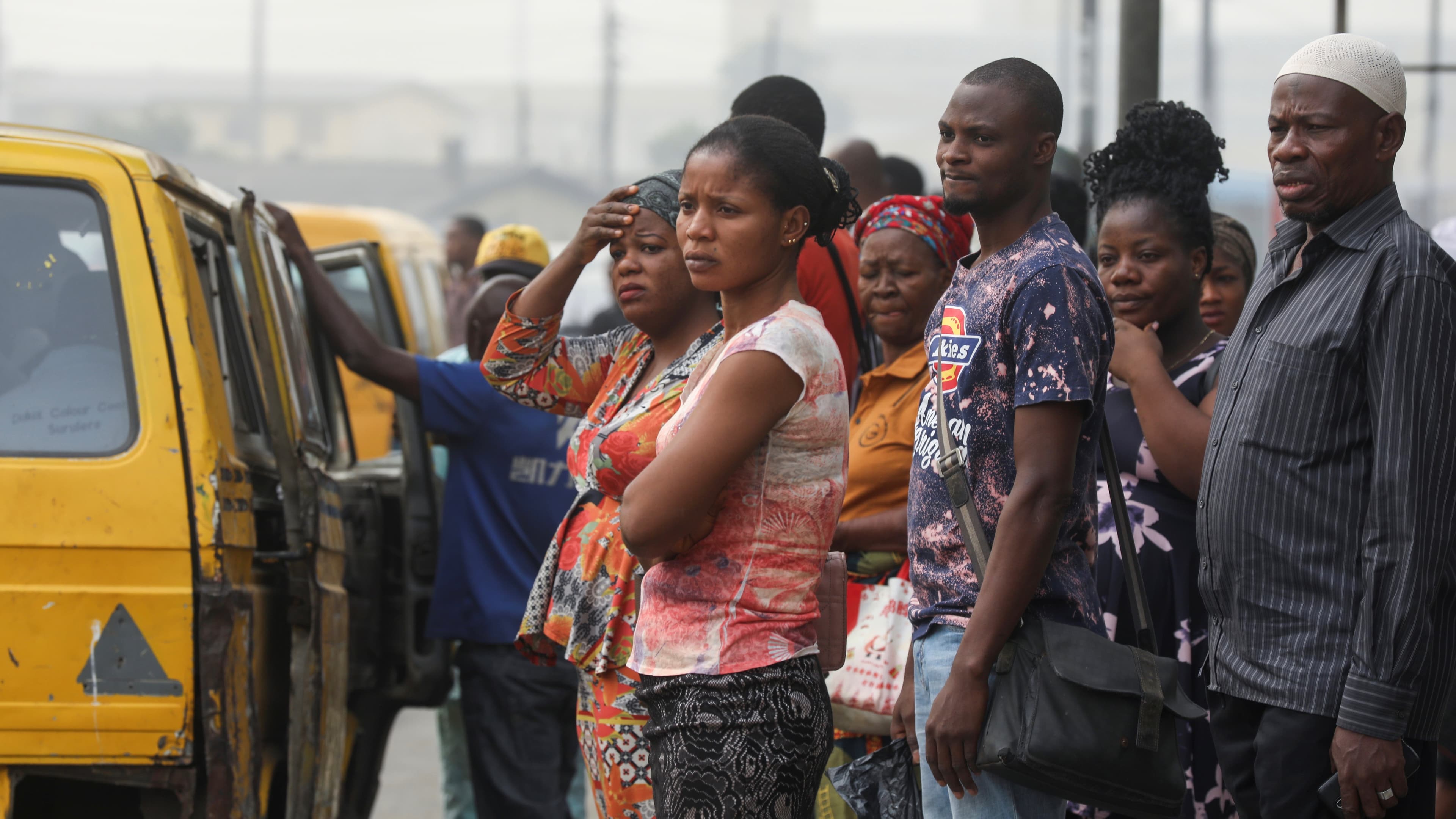 People are seen waiting for a bus at a bus-top in Lagos, Nigeria, Feb. 13, 2020.