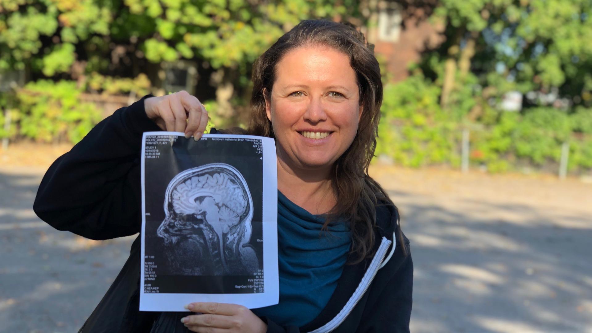 Polyglot Susanna Zaraysky holds a printout of her brain scan from the Massachusetts Institute of Technology polyglot test. 