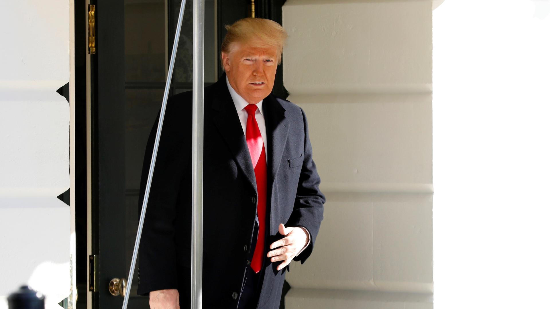 US President Donald Trump walks out from the the White House in Washington before his departure to India, Feb. 23, 2020.