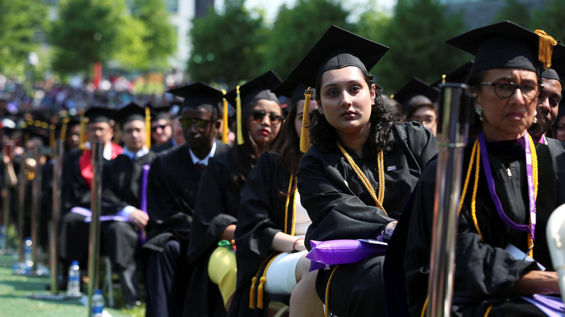Graduates of The City College of New York sit in their seats at their commencement ceremony in Manhattan on May 31, 2019.