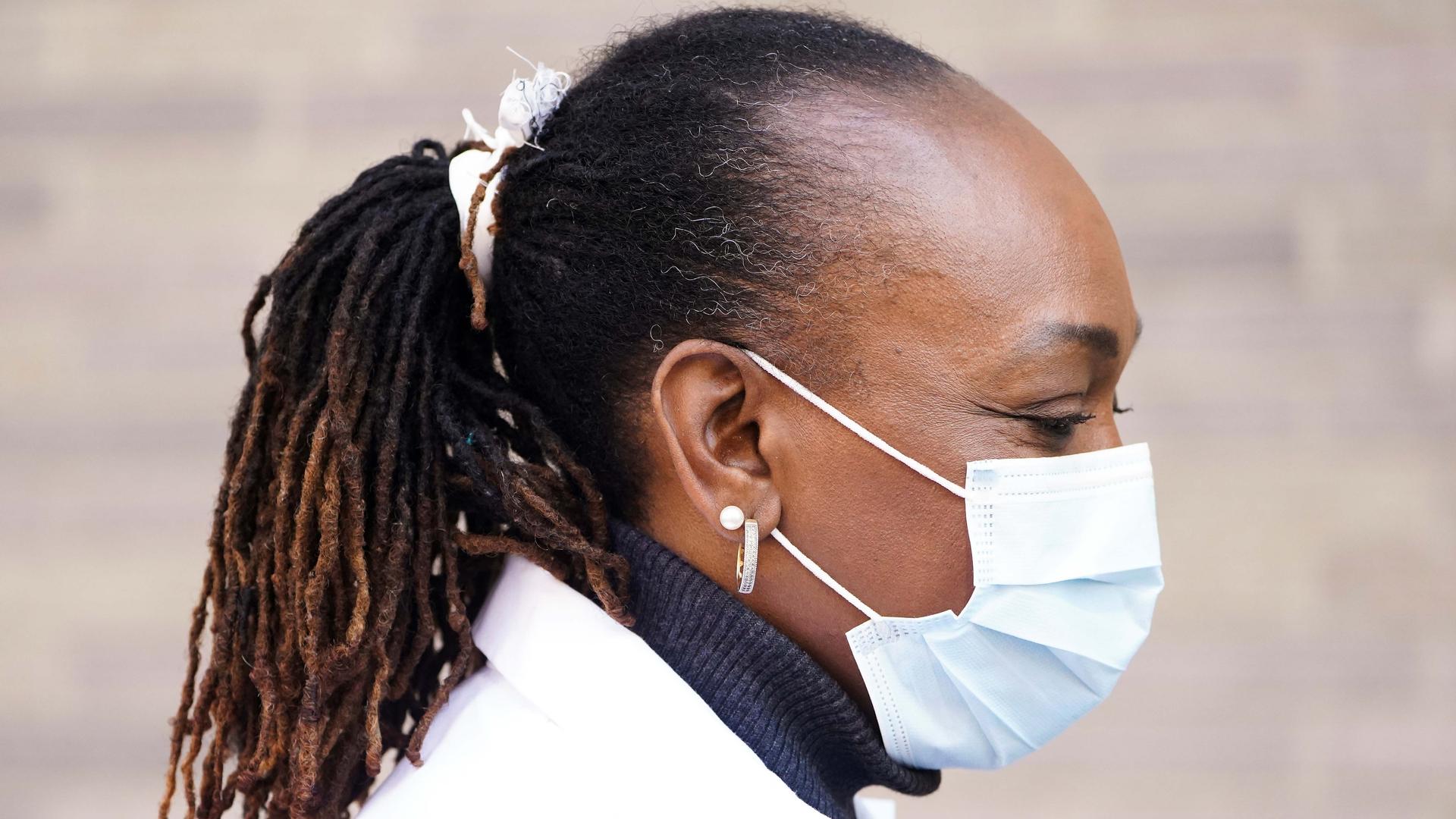 A health care professional wearing a protective face mask walks into a hospital following the outbreak of coronavirus disease (COVID-19), in the Manhattan borough of New York City, New York, US, on March 18, 2020.