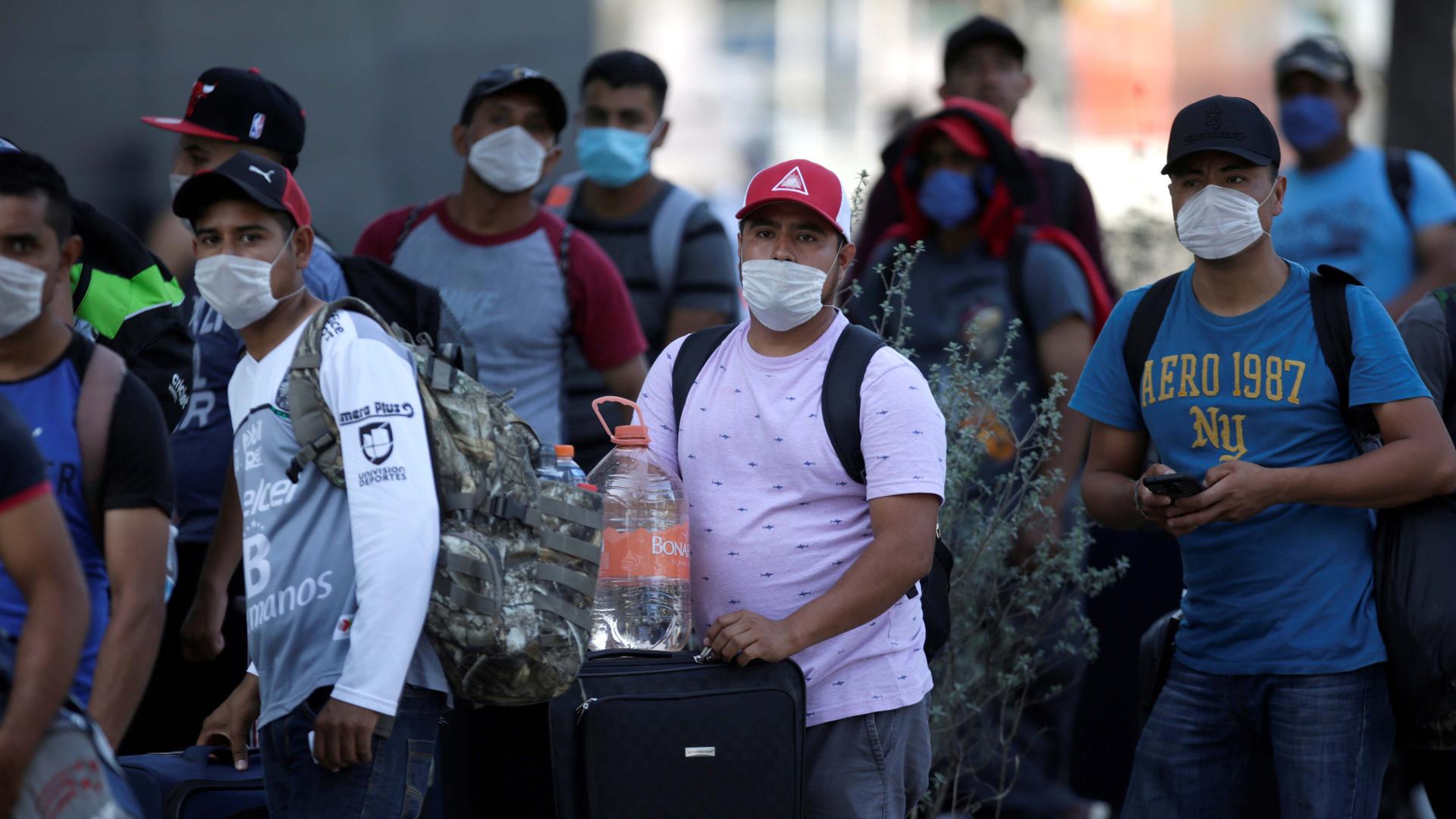 Migrants seeking for a U.S. work visa are pictured after being evicted from their hotel, which local authorities said was crowded, as part of the measures to prevent the spreading of the coronavirus disease (COVID-19), in Monterrey, Mexico March 24, 2020.