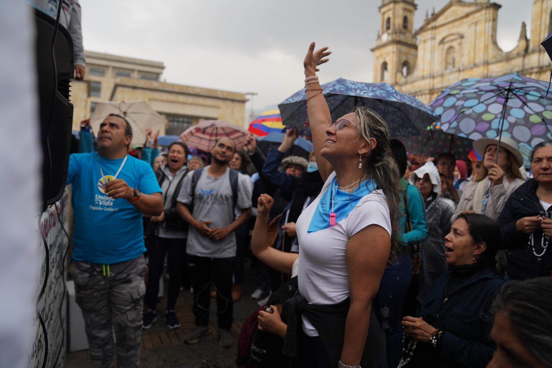 A demonstrator prays during a protest against efforts to liberalize abortion outside a cathedral in Bogotá, Colombia, Feb. 22, 2020.
