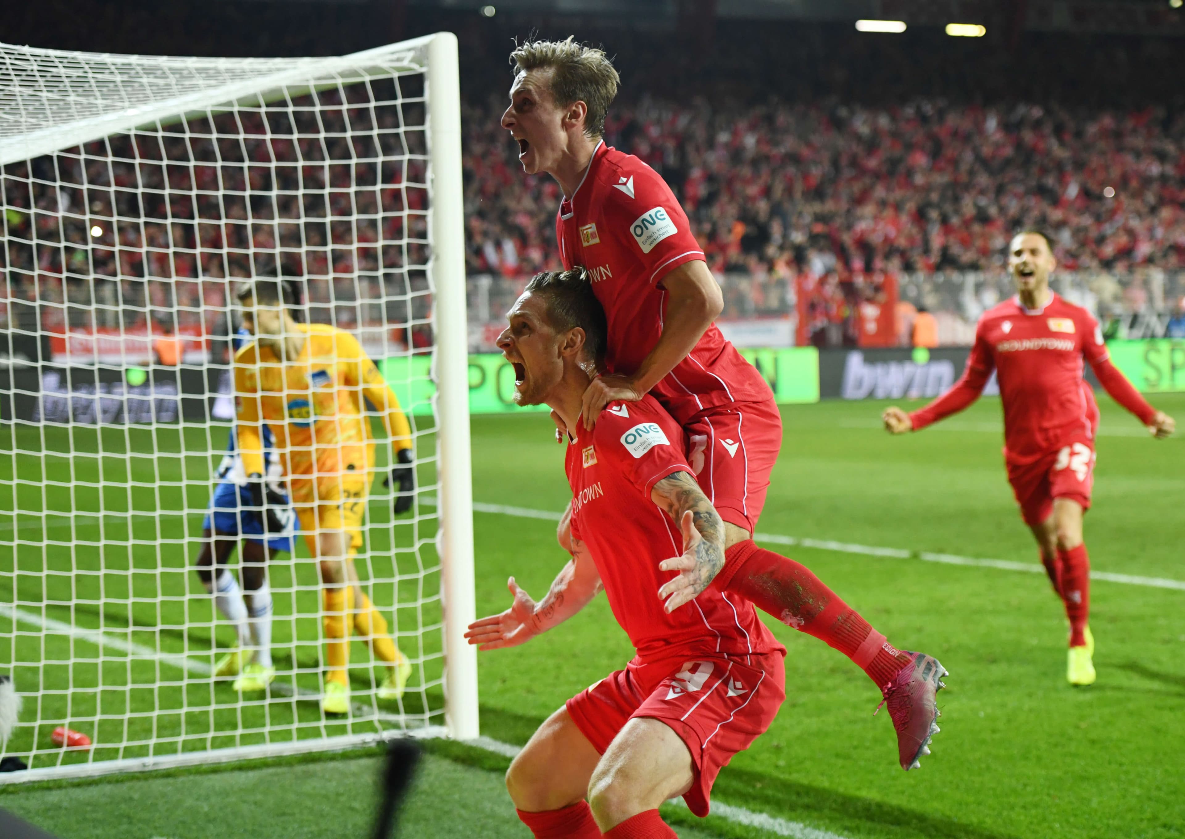 1. FC Union Berlin's Sebastian Polter celebrates scoring their first goal with teammates, Nov. 2, 2019, Berlin, Germany.