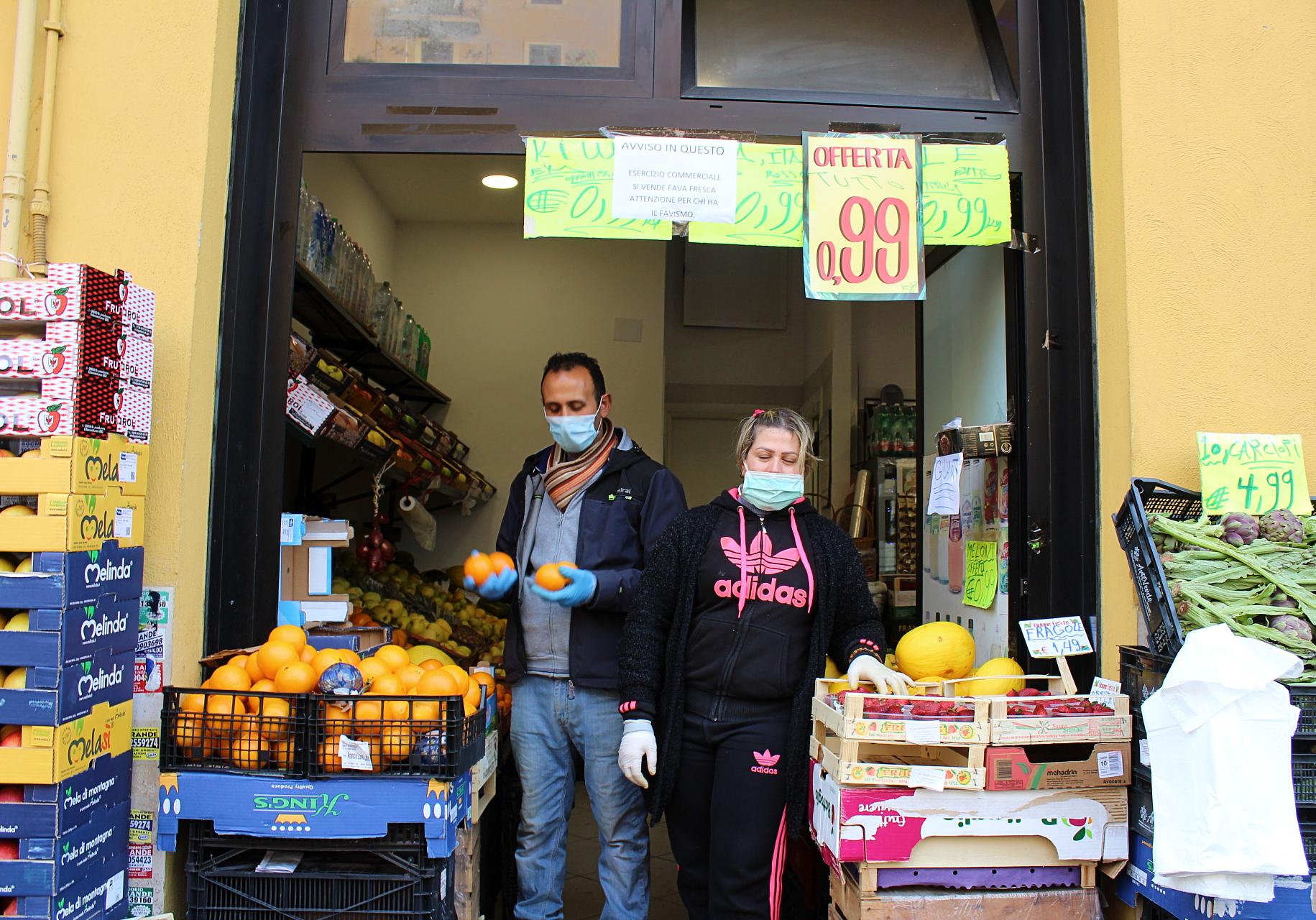 Groceries, like this fruit shop in Torpignattara, Italy, are allowed to stay open