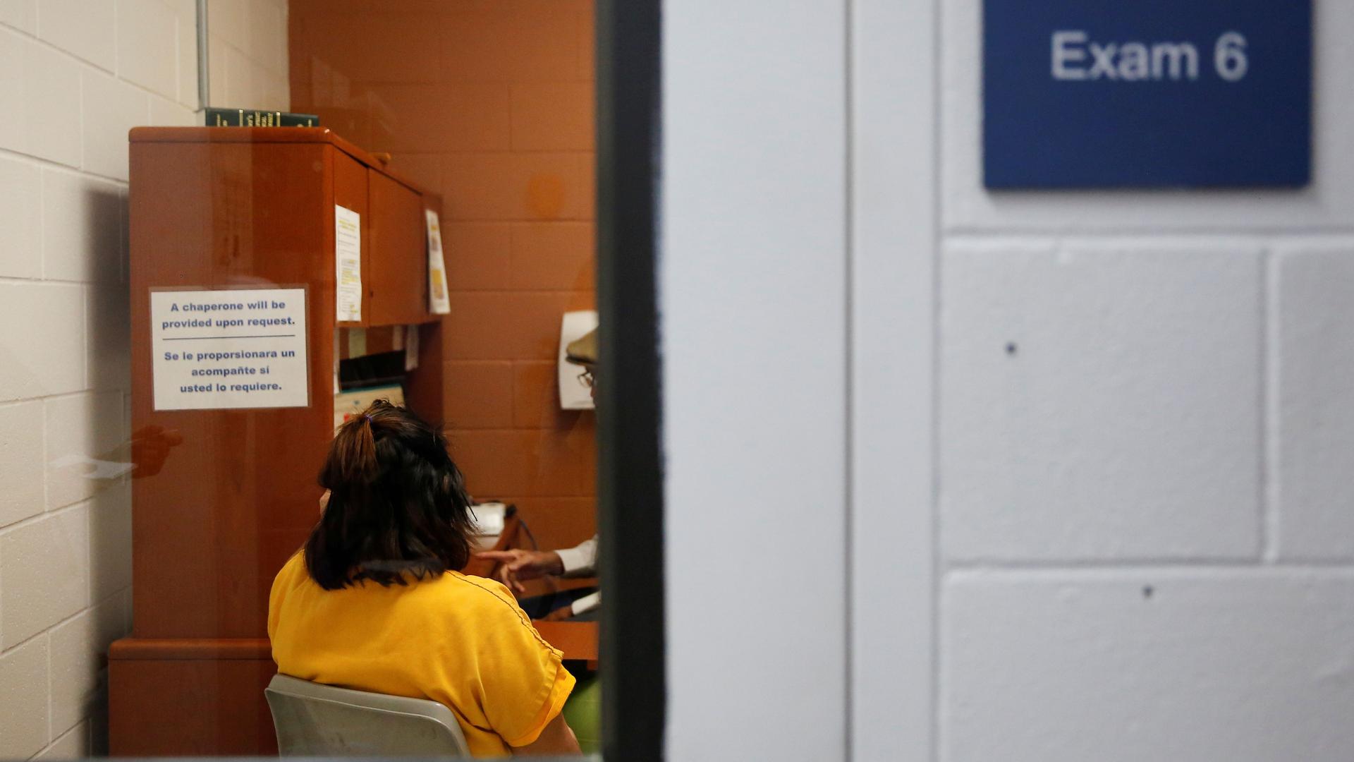 A detainee talks with an employee in an exam room in the medial unit during a media tour at Northwest ICE Processing Center, one of 31 dedicated ICE facilities that house immigration detainees, in Tacoma, Washington, Dec. 16, 2019. 