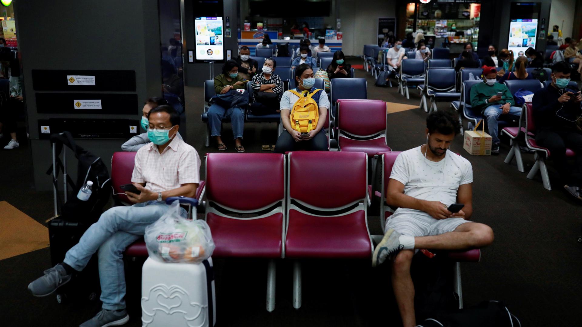 Passengers wear protective masks due to the coronavirus outbreak, at Don Mueang airport in Bangkok, Thailand, March 9, 2020. 