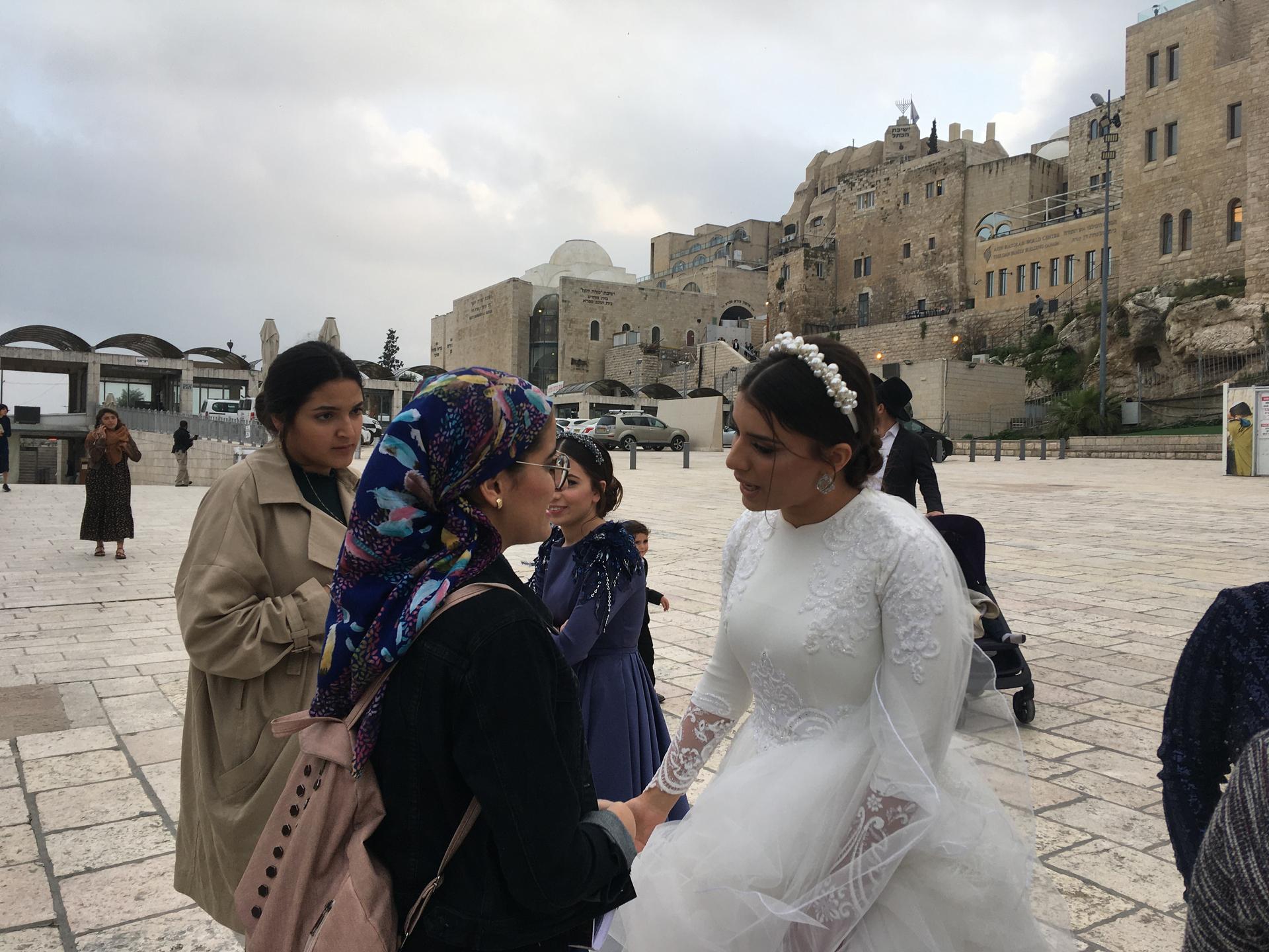 Idit Tedgi gets close to other worshippers to offer blessings on her wedding day.