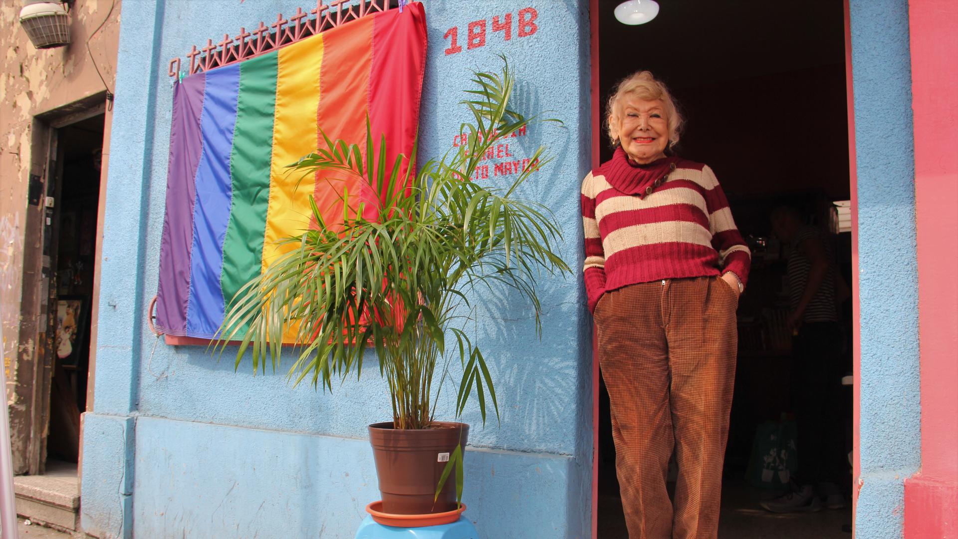 Samantha Flores, a trans woman, stands at the entrance to the Vida Alegre, a day center for older LGBTQ people in Mexico City that she cofounded. 