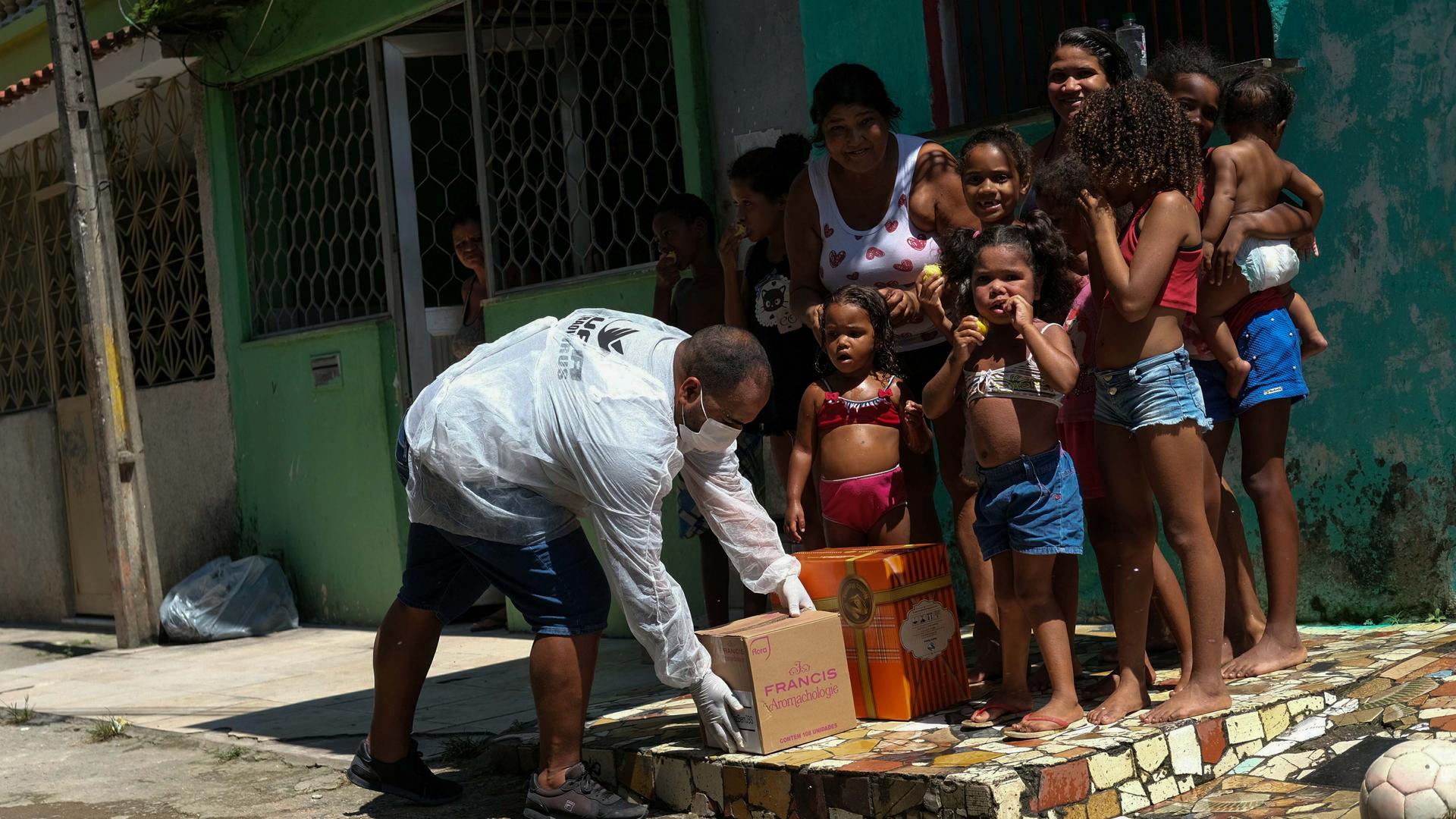 A volunteer delivers donated aid to poor families in Rio de Janeiro's slums through Single Centre of Slums (CUFA) during the coronavirus disease (COVID-19) outbreak, in Vila Kennedy slum in Rio de Janeiro, Brazil, on April 2, 2020.