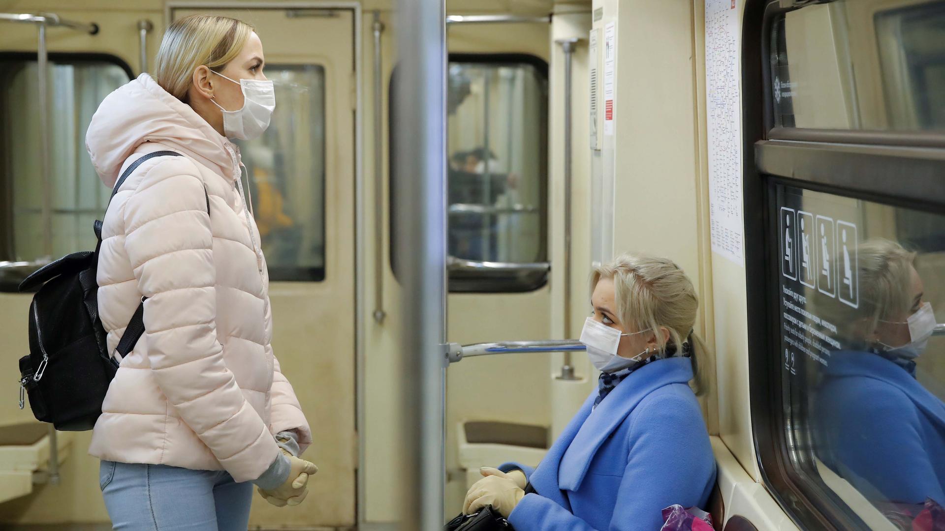 Women wearing protective masks travel in a metro train during a partial lockdown imposed to prevent the spread of coronavirus disease (COVID-19) in Moscow, Russia, on April 2, 2020.