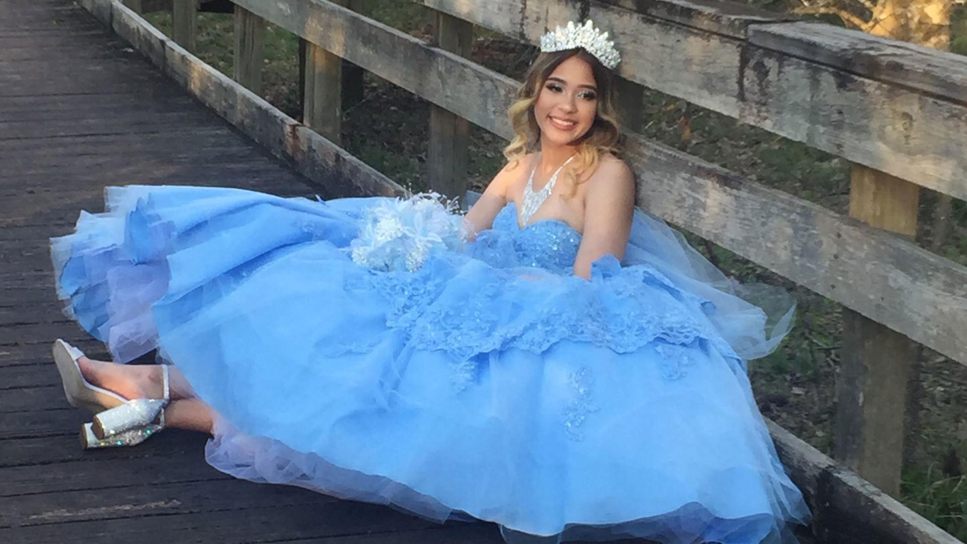 Katelynn Taveras, a teenager in Houston, Texas, poses in the pale-blue dress she selected for her quinceañera. The party was canceled due to the coronavirus outbreak.