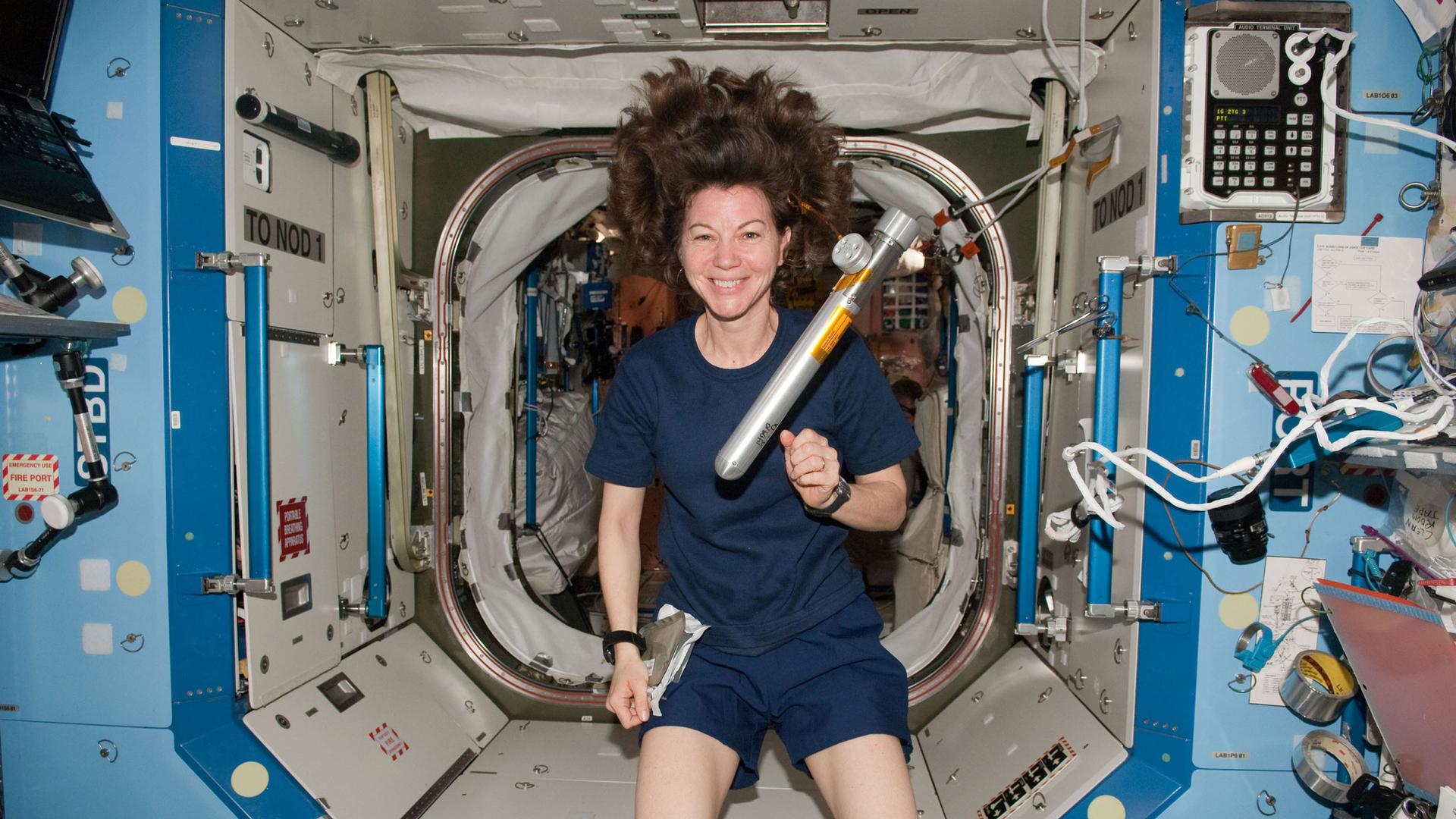 A woman floats in a spacecraft
