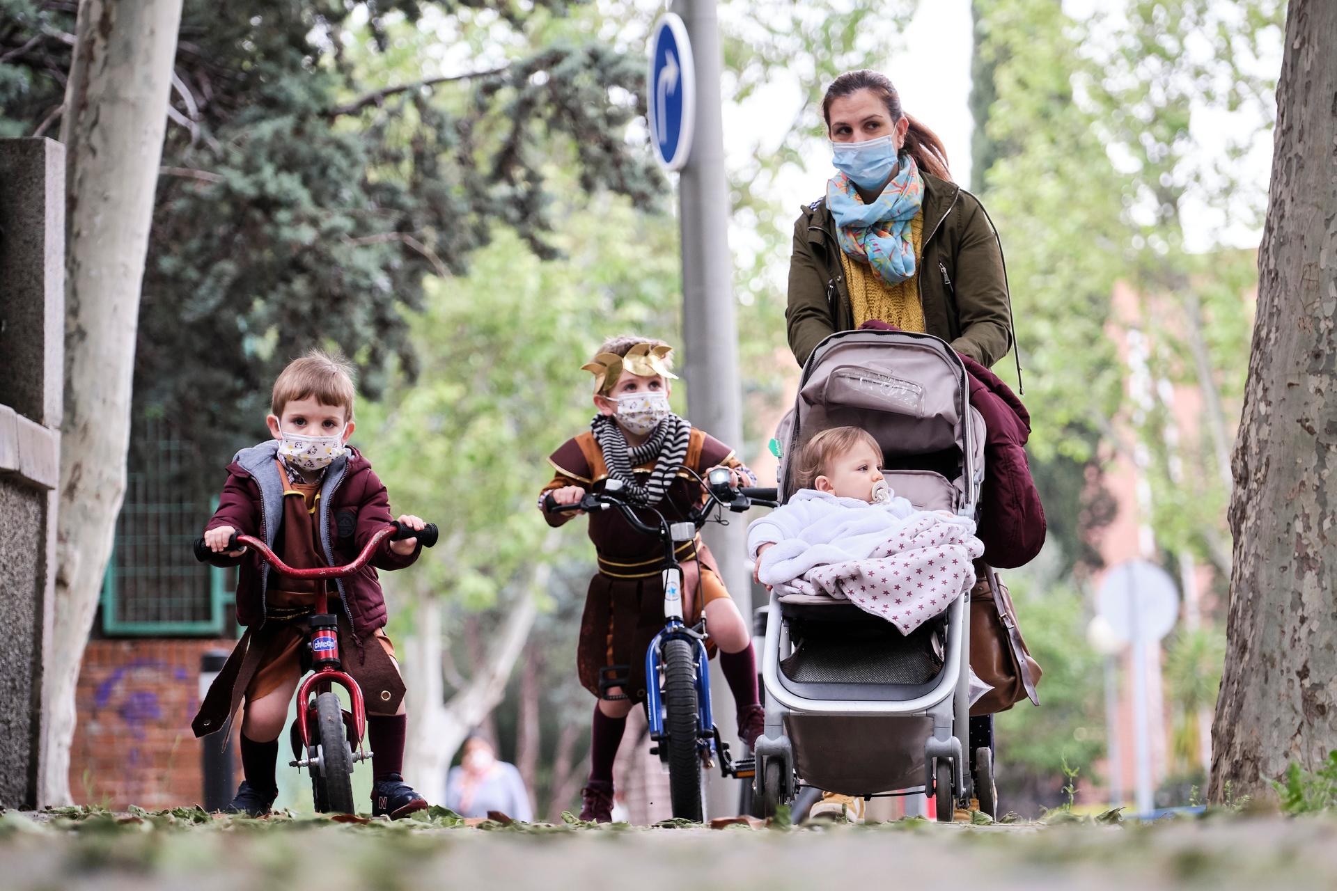 Begoña, a mother of three, takes her children for a walk on the day Spain lifts restrictions on children outdoors due to the coronavirus pandemic