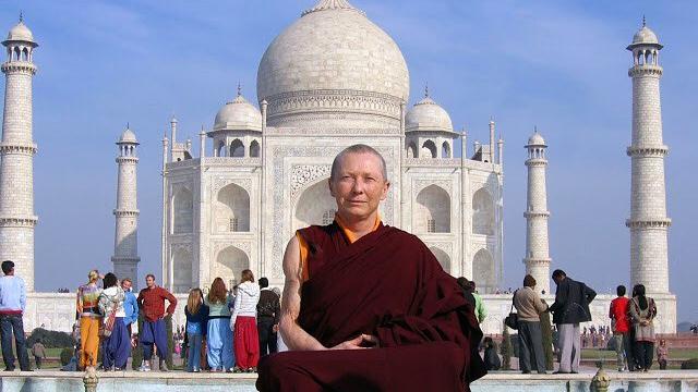 A Buddhist nun sits in front of the Taj Mahal 