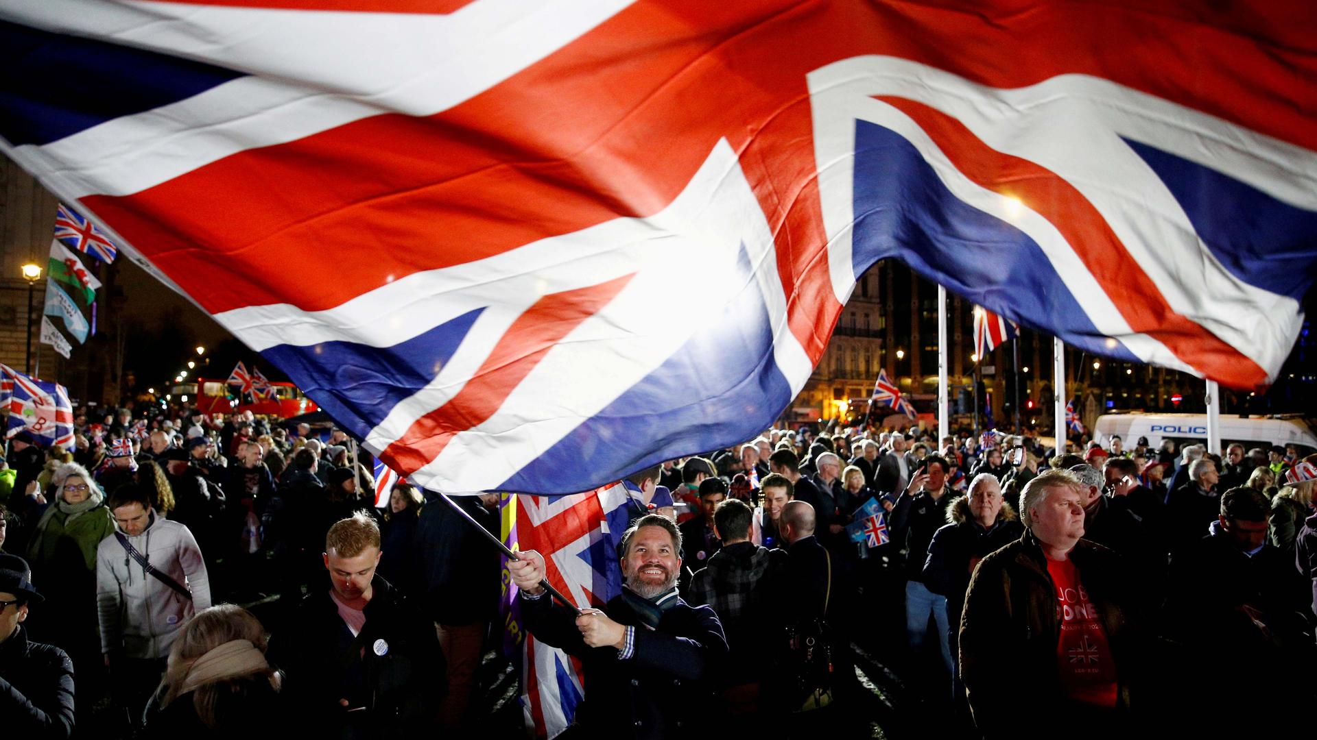 A man waves a British flag on Brexit day in London, Britain, on Jan. 31, 2020. 