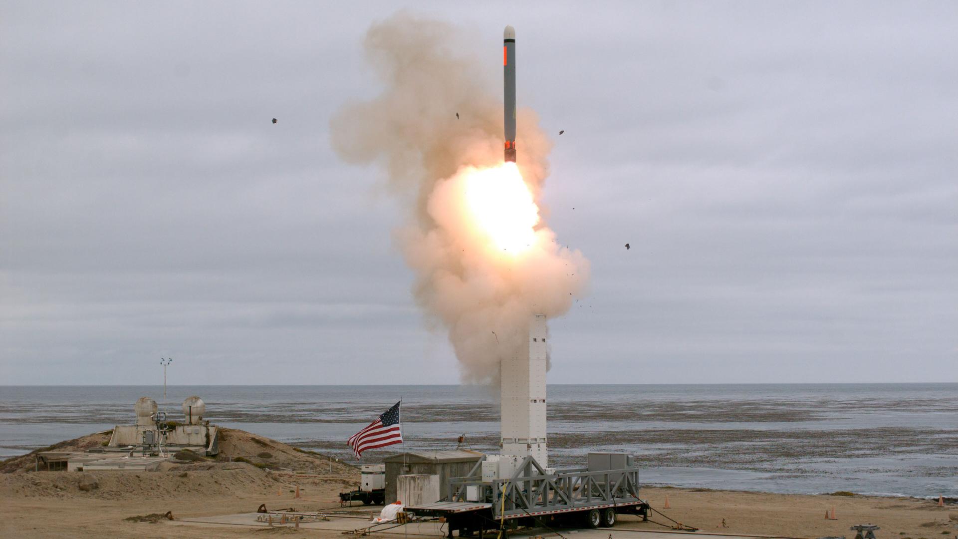 A view of a test missile launch with an American flag flying