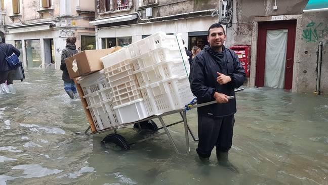 A Rizzo bakery employee delivers bread during the November 2019 floods in Venice.
