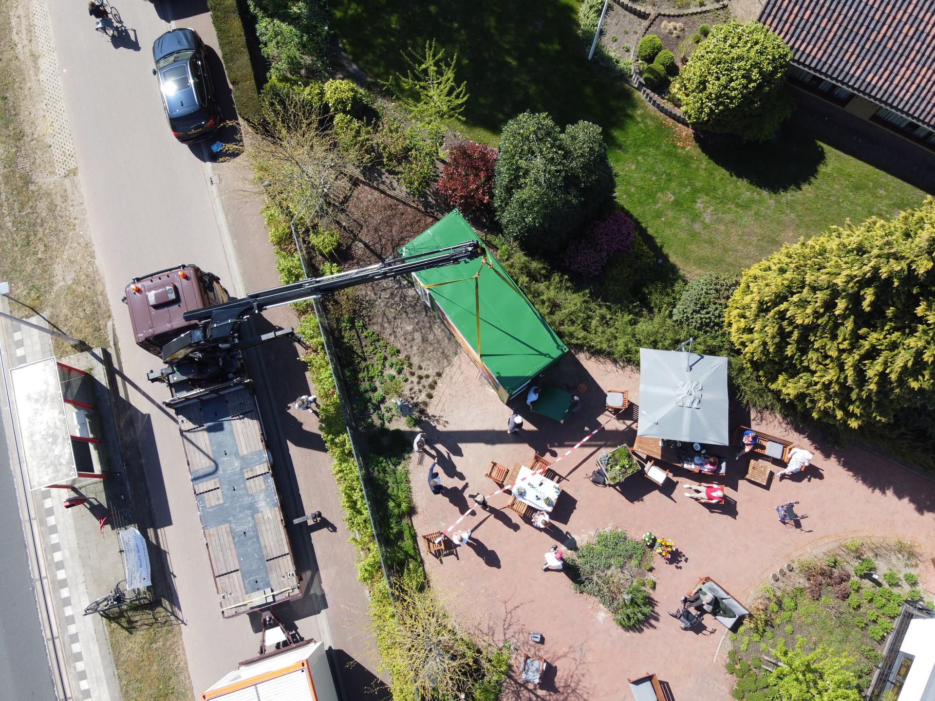 Installing the glass cabin with a large crane, aerial shot.