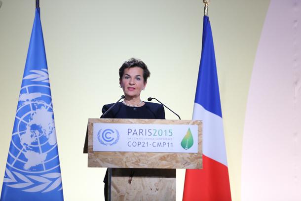 A woman speaks at a podium 