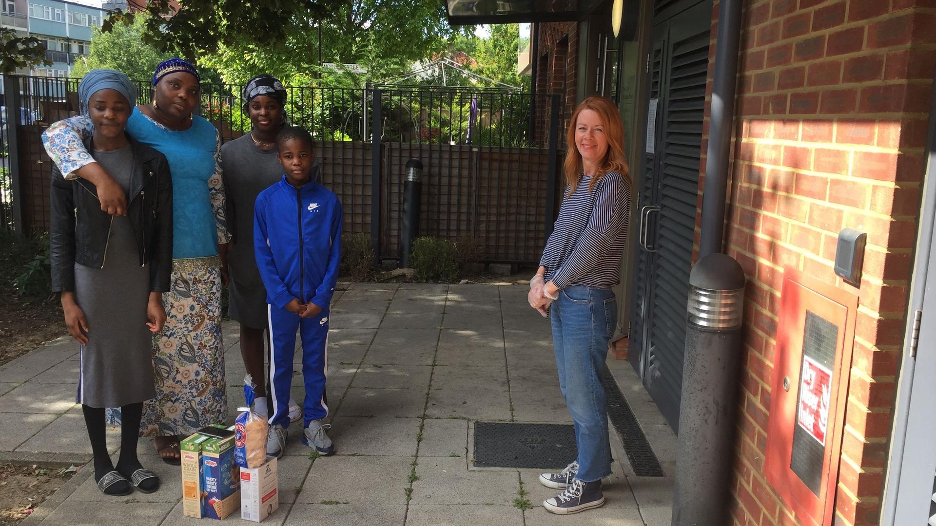 Fi Carrick-Davies poses with Bola Fagbemi and her children Fathia, Aishat and Abdul-Qayyum Akintoyese after dropping off some food for them. Carrick-Davies and the family are extremely close. 
