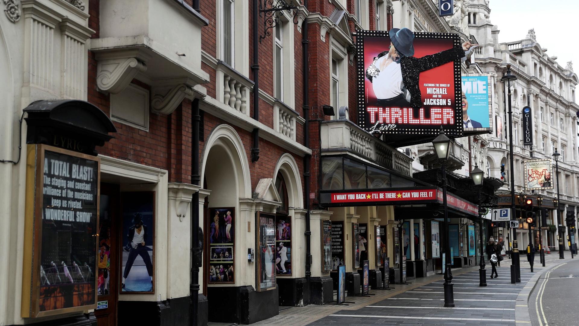 West End theaters stand on a sparsely populated street in London, March 13, 2020.